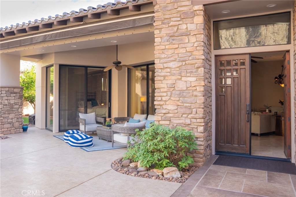 Experience the epitome of luxury living with unparalleled views and a prime location in the esteemed Point Happy Estates of La Quinta. This FULLY FURNISHED TURN KEY retreat is nestled against the majestic mountains in a tranquil neighborhood, this rare opportunity offers a secluded retreat within walking distance to exquisite dining, shopping, and coffee shops. Perfectly positioned for outdoor enthusiasts, it's just minutes away from exceptional hiking trails. Step inside to discover a home adorned with exquisite upgrades, including a Thermidor gas range, built-in stainless steel refrigerator, and luxurious travertine tile floors complemented by lofty 12' ceilings. Recent upgrades include a new 2-zone A/C system, garage A/C, patio misters, and a retractable awning, ensuring comfort and convenience year-round. Wake up to breathtaking mountain vistas from your primary suite, complete with a cozy fireplace for added ambiance. Indulge in the spa-like primary bathroom featuring a walk-in shower and spacious dual sinks. Two additional generously sized guest bedrooms offer private en-suite bathrooms, providing the perfect accommodations for visitors. Entertain in style in the open-concept living room, seamlessly flowing onto the poolside patio, where the awe-inspiring mountain views serve as a stunning backdrop. Enjoy the serenity of your own private oasis amidst meticulously manicured grounds on an oversized lot. Discover the ultimate blend of luxury, comfort, and natural beauty in this extraordinary La Quinta retreat.