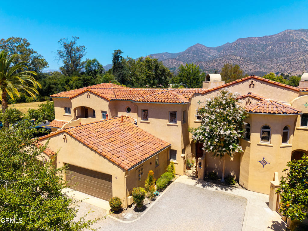 Experience Tranquility in the Heart of OjaiTucked away in a quiet enclave just steps from the iconic Ojai Arcade, this luxury condominium offers the best of both worlds: peaceful living in the center of it all. Designed by renowned architect Marc Whitman, this two-story Mediterranean-inspired home combines timeless elegance with modern comfort--all just moments from the Ojai Art Center, Libbey Park, and scenic bike paths.Imagine starting your day with a stroll under the oak-lined streets for a cappuccino and croissant from the Duchess, playing a morning match on the Libbey Park tennis courts, then browsing the farmers market before returning to your serene retreat.With three generously sized en suite bedrooms--including a convenient ground-floor suite ideal for guests or a home office--this home offers flexibility and privacy. The expansive primary suite includes a generous walk-in closet and a beautifully appointed bathroom featuring classic tilework, a soaking tub, and a spacious walk-in shower. The guest suite offers a balcony with mountain views. The chef's kitchen is outfitted with premium GE Monogram stainless range, newer dishwasher and microwave. A spacious laundry room with custom built-ins and a sleek, oversized two-car garage with epoxy floors and wall-to-wall storage add unmatched convenience.Outdoors, the private patio feels like your own garden oasis, complete with mature citrus trees and a cozy fireplace for evening dinners. Additional upgrades include a tankless water heater, dual-zone HVAC system with UV air purification, and independent climate control on each level. Whether you're looking for a peaceful full-time residence or a low-maintenance weekend getaway, this is a rare opportunity to own a home in one of Ojai's most cherished locations.