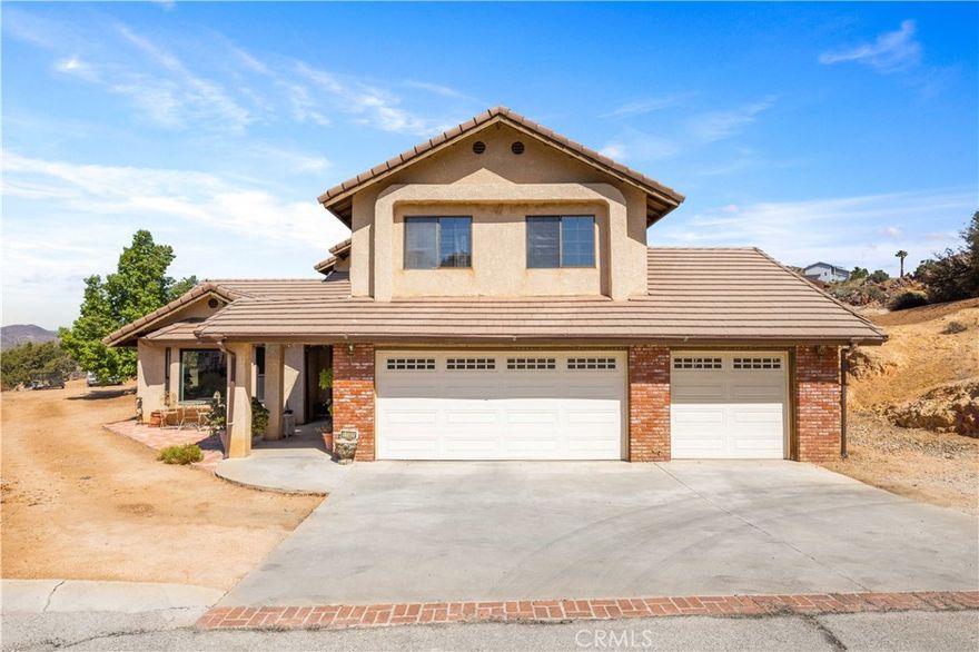 Charming two-story home located at the end of a cul-de-sac in the desirable Country Way Estates neighborhood in the small town of Acton! Panoramic views take your breath away as you embark upon this 4 Bed, 3 Bath, 2,476 sqft home on 2.14 Acres. Great layout with all the right spaces: entertain in the formal Dining and Living rooms; relax in the cozy Family Room with fireplace; or host gatherings in the well-appointed Kitchen. The kitchen is spacious, with classic tile counters, oak cabinets, a sweet garden window, and abundant storage, including a walk-in pantry. It is adjacent to the breakfast nook, which flows seamlessly into the Family Room. There is access to the back patio from both the dining and family rooms, extending entertaining space. All 4 bedrooms are on the second floor, including the Primary Bedroom, which is a retreat, with its own private balcony and attached bathroom with separate shower, soaking tub, dual sinks, plus a walk-in closet. Three more bedrooms and a full bathroom will accommodate a large family or guests. An indoor laundry room is a welcome convenience providing extra storage and has direct access to the 3-Car garage. The property has the perfect blend of space with with a cross-fenced backyard and enough room for RV parking or animals. Easy country living on paved roads with county water, natural gas and close access to schools, the park, shopping and the freeway.