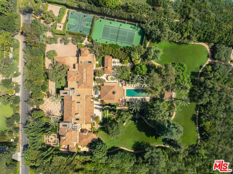 3.5 acres completely flat makes this one of the most important estates in Los Angeles. Mallorcan Villa designed by renowned architect Bob Ray Offenhauser and built by Peter McCoy Construction. Timeless and Elegant, seamless blend between interior and exterior spaces. The Villa is in pristine condition with exquisite detail, extensive use of imported stone and exceptional steel windows/doors by Architectural Iron Works. Soaring 20ft coffered ceilings in the living room. 2-story dining room and library are perfect backdrop for grand entertaining. Indoor-outdoor pavilion/bar overlooks the infinity edge pool and pool cabana. Primary suite is a world apart with views over vast lawns, reminiscent of Montecito. Double baths with individual pocket gardens. Additionally, there is a large guest suite, 4 generous family bedrooms each with homework areas, a junior guest room and staff bedroom. Totaling 8 bedrooms. Additional features of the estate include: gourmet kitchen and catering kitchen, large gym, 1,200 bottle wine cellar, game room, oversized 4-car garage, and a service building with separate entrance. Gardens designed by Todd Bennitt. The grounds feature: rolling meadows, olive allee, formal rose gardens, courtyards, water features, tennis court and sports court. All in complete privacy. A work of art to be cherished and celebrated. Shown only to prequalified buyers.