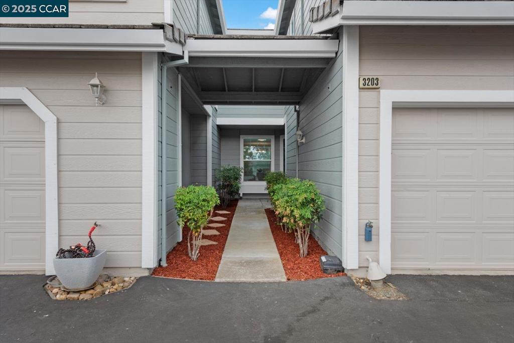 Tucked away with a private walkway to the entry, this charming Clayton condo offers a welcoming and thoughtfully updated living space. The bright kitchen features abundant storage, freshly painted white cabinets, and two dining areas for flexible living. The cozy living room includes a wood-burning fireplace, perfect for relaxing evenings, and a sliding door that opens to a spacious stone patio—ideal for BBQs and entertaining guests. Upstairs, you'll find two generous primary suites with soaring ceilings, each complete with an en-suite full bathroom and walk-in closet. The home is clean and move-in ready, showcasing new interior paint, updated light fixtures and ceiling fans in the bedrooms. Additional highlights include two single-car garages—one attached with interior access and one detached. Ideally located near Mt. Diablo State Park and downtown Clayton’s restaurants, shops, and community charm.