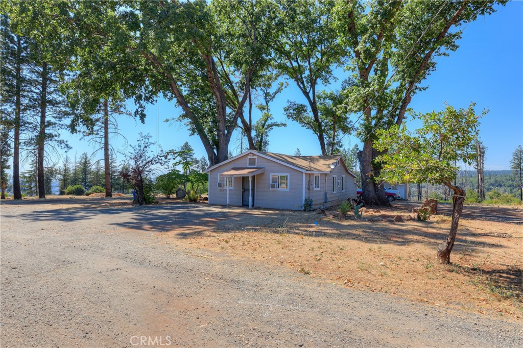 Charming 2-Bedroom home on nearly 4 Acres in Paradise, CA. If you’ve been dreaming of peaceful living with room to breathe, this cozy 2 bed, 1 bath home in Paradise might be just what you’ve been waiting for. Nestled on approximately 3.74 acres, this property offers a rare mix of privacy, usable land, and a beautiful distant view of Butte Creek Canyon. The home sits on a level homesite near the top of the property, making for easy living and room to expand if desired. From there, the land gently slopes down, giving you space to explore, garden, or just enjoy the outdoors. Zoned TR1/2, there's potential here for so much more—whether you're looking to create your own homestead or simply enjoy the wide-open space. Step inside and you’ll find a home that’s welcoming, full of character, with just the right amount of charm and potential to make it your own. Whether you're starting fresh, downsizing, or looking for a weekend retreat, this place offers a quiet escape with room to grow. Come take a walk around, soak in the views, and see what life could look like here in Paradise.