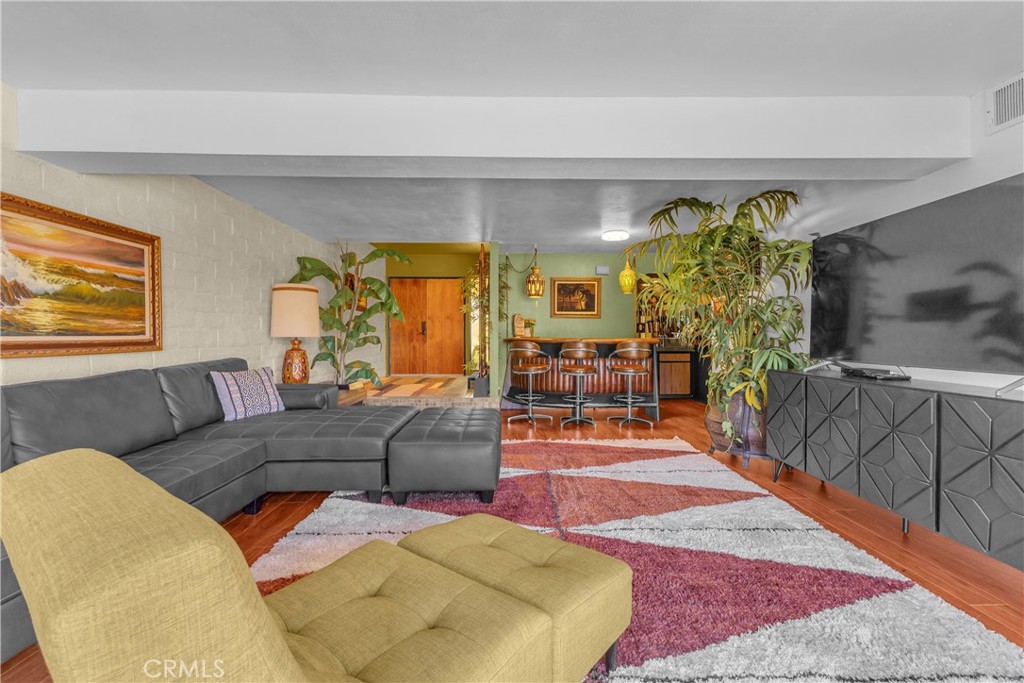 Furnished 2 Bedroom Condo with Tiki Bar, Airbnb Ready, Golf & Pool Resort-style living in Cathedral Canyon Country Club! This updated two-story condo blends retro charm with tropical flair, perfect as a full-time home, weekend retreat, or income property (Airbnb). Located on a quiet cul-de-sac with no-one above or below you. The layout offers two spacious en-suite bedrooms, ideal for comfort and privacy. Downstairs, the open-concept floorplan includes a cozy living area with built-in bar, a dining space just off the kitchen, and sliding doors that lead to a private enclosed patio overlooking lush greenbelt space, great for relaxing or entertaining. The attached two-car garage has additional room for a golf cart and direct access into the home. Recent updates include fresh interior and exterior paint, newer flooring, updated kitchen appliances and washer/dryer, newer A/C system, insulated garage door, and a refinished upper deck. Cathedral Canyon Country Club is a gated community offering an 18-hole golf course, tennis courts, multiple pools and spas. including one just steps away, a clubhouse with dining and bar, golf shop, putting green, and driving range. Move in ready and located in one of the desert's most welcoming communities! Whether you're looking to live in comfort year-round or offer an unforgettable vacation rental, this condo brings the best of Cathedral Canyon Country Club right to your door.