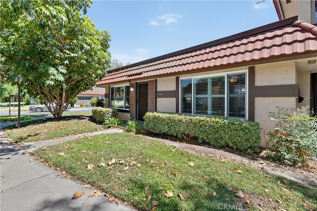 RECENTLY REMODELED SINGLE-FAMILY HOME ON A CORNER LOT, ATTACHED ON ONLY ONE SIDE, NO ONE ABOVE OR BELOW, WITH PATIO ACCESS TO 2-CAR GARAGE! Open floor plan and large windows, all with plantation shutters, bring in lots of natural light. Living room is open to dining room, and dining room is open to remodeled kitchen with recessed lighting, quartz countertops, and stainless-steel appliances. Kitchen windows and sliding glass doors in dining room and one of the back bedrooms open to a large private back patio with wood fence and block wall, where you can relax and barbeque. Recently painted, and newer laminate flooring throughout except for carpet in primary bedroom. Large primary bedroom has ensuite full bathroom. Down the hall is a second full bathroom, and two additional bedrooms at the back of the home. Newer Central A/C and water heater, dual-pane windows, and smooth ceilings. Ceiling fans in all bedrooms, and recessed lighting in living room, dining room, kitchen and one of back bedrooms. Community has an association pool, and is next to Boisseranc Park, a public park with lighted tennis courts, heated pool, handball courts, baseball fields, playground, and picnic area. Conveniently located near 91 and 5 freeways.