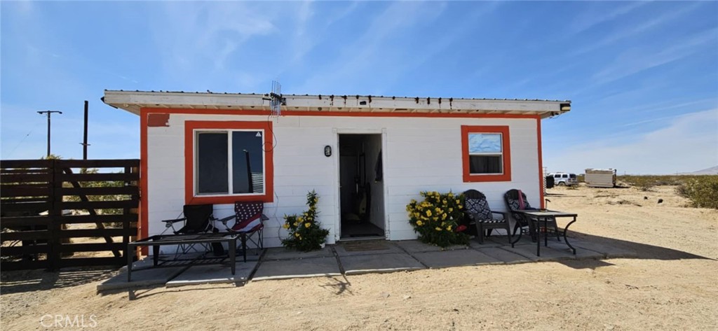 SELLER FINANCING AVAILABLE! Check out this studio-style cabin on 3.75 Acres with utilities & views! Located in the peaceful outskirts of 29 Palms, this one-room cabin is a unique find with tons of potential! The layout includes an open-concept kitchen, walk-in shower, and sleeping area with a toilet ready for a creative makeover. The cabin is connected to solar panels and there is also an Edison power pole on-site. Water is currently supplied by a 1200 gallon water tank. There is also a well on site but the condition is unknown. The property is being sold AS-IS, with no repairs or improvements to be made by the seller. Some personal items will be removed prior to closing, while others may stay—buyers can request certain items be included. There are also vehicles on the property; the seller is open to negotiating them as part of the sale. With few neighbors, open skies, and stunning desert and mountain views, this is a great opportunity for an investor, flipper, or visionary buyer. Bring your vision and make this property yours! Schedule a viewing today! APN: 0633-181-02-0000. Latitude:34.241093, Longitude:-116.156826.