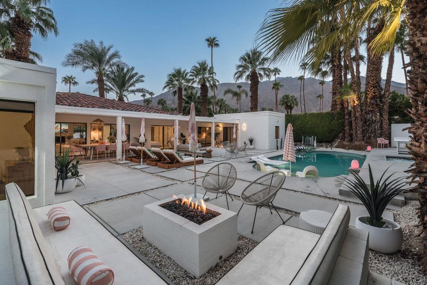 Own a rare, fully-updated, walled-compound estate in Old Las Palmas--Palm Springs' most iconic luxury neighborhood with no HOA and no gated-community restrictions. This designer-furnished desert retreat blends sophistication with unbeatable walkability to downtown Palm Springs' dining, shopping, and nightlife.Inside the home, you'll find brand-new flooring, a completely reimagined chef's kitchen, fresh designer paint, and curated high-end furnishings that make the home feel like a private boutique escape. The layout is ideal for homeowners and investors alike, featuring two private attached casitas (each with separate entrances and ensuite bathrooms)--perfect for hosting guests, generating rental income, or creating an ultra-private multi-suite compound lifestyle.Step outside to majestic western and mountain views of San Jacinto from both the front courtyard and resort-style backyard. The property is fully walled and gated with a remote-controlled entry gate for vehicles, offering the privacy and exclusivity of a traditional estate.Enjoy a sun-drenched pool + spa, expansive luxury resort deck, tranquil ambiance, and dramatic California sunsets that illuminate the mountains with gold. Whether you're seeking a primary residence, vacation retreat, or income-producing investment, this property qualifies for a short-term rental permit through the City of Palm Springs, making it a premium opportunity to own an asset that can help fund your future vacations while building equity.Live the Palm Springs estate lifestyle in the desert's most sought-after, non-gated, no-HOA luxury neighborhood--where privacy, design, and location converge into something extraordinary.Compound Estate ✔ No HOA ✔ Walk to Downtown ✔ Casitas ✔ Pool & Spa ✔ STR Permit Eligibility
