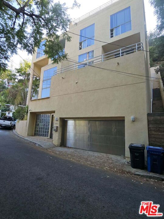 Hollywood Hills Contemporary Multi-Level Design, Spectacular Sweeping City Views. In one of the most Coveted Locations. Four levels across a versatile floor plan maximize both privacy and entertainment options. This West Hollywood Home features Dramatic open staircase that reaches to the top level as part of its design. Second level features two bedrooms and a bath, there is a large balcony to enjoy the Wonderful City Views and Sunsets. Third level opens up to an expansive floor to ceiling set of Stunning Picture Windows with Stunning Jet Liner Views from the City to Ocean. There are city views from most angles on this level. Open concept floor plan with living room, dining room, kitchen, bath that has a wraparound design with high ceilings, recessed lighting, The dining room leads to the outdoor Spacious patio with BBQ, Spiral staircase to another upper-level patio with Dramatic City and Hill Views. Off the living room a short flight up sits alone a Private Master Suite with a cozy fireplace with Fantastic City Views. Master bathroom features a spa tub, skylight, there is a Private Elevator that takes you to most floors. Two car garage that leads to a guest quarter that also features a built-in Soundproof Recording Booth, Large lot with opportunity to add value. Quite street located just above the Sunset Strip and Sunset Plaza, Heartbeat of the Vibrant Culture. This is a Fabulous Location in the Hollywood Hills West. A rare opportunity for a visionary to redesign this home, make it the way YOU won't it, a true Diamond in the rough with many possibilities to restore this Spectacular Estate