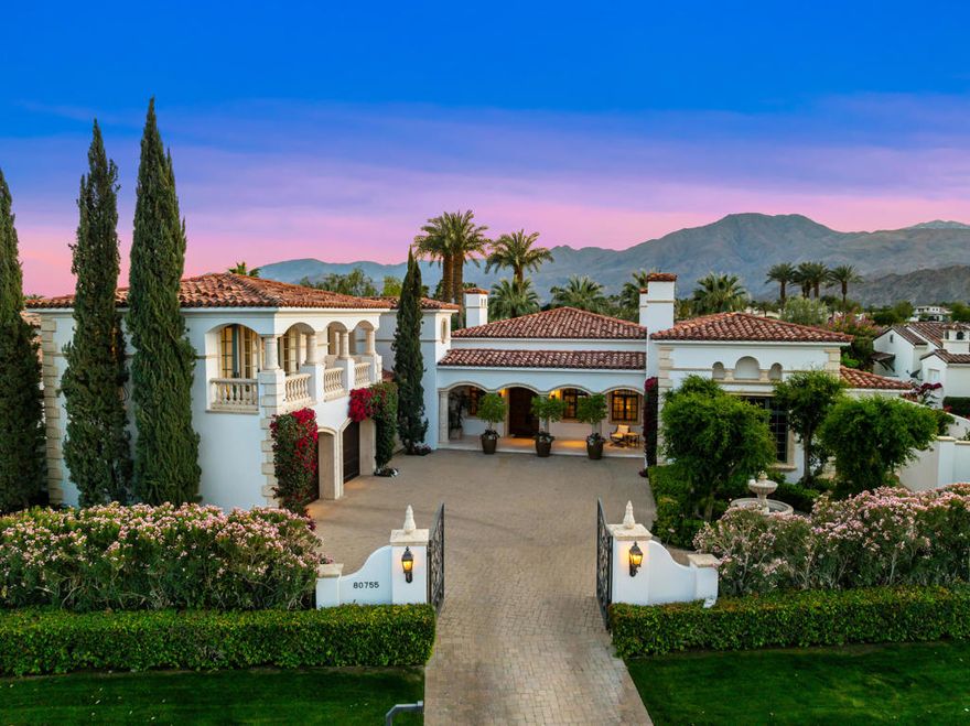 Privately gated, classic custom Mediterranean, South facing, with incredible lake and mountain views located on the 18th of the Clive Clark course.  4 BD, 4.5 BA + library/office/bonus/game room.  Approx. 5,279 sq. ft. on .38 acre lot.  Truly elegant home featuring formal living room with fireplace, formal dining room, beautiful bright country kitchen with center island/counter bar and breakfast nook.  Wine cellar and handsome all wood combination library/office and game room with fireplace.  Large primary suite with inviting bath.  Extended loggia with outdoor living room with fireplace and dining.  Custom pool with raised spa and outdoor shower.  Offered furnished per inventory!
