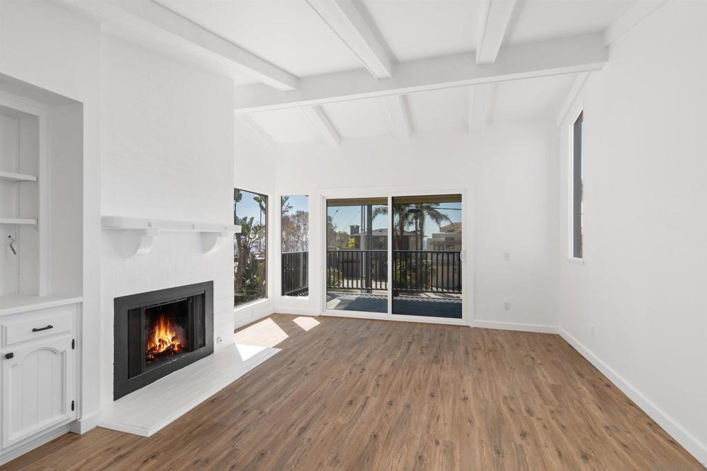 Pacific Ocean Views! Beautiful Encinitas Beach Home just steps from iconic Moonlight Beach! This updated two-story gem features quartz countertops, stainless steel appliances, wood floors, and fresh paint throughout. Enjoy ocean views from the vaulted-ceiling living room with fireplace and private deck. Spacious primary suite with custom built-ins and ample closet space. Private balconies off both downstairs bedrooms. Includes 1-car garage with storage and 1 off-street parking spot. Walk to shops, dining, Coaster station, and all that Olde Downtown Encinitas has to offer! Coastal Elegance Just Steps from Moonlight Beach Welcome to your dream beach home in the heart of Encinitas, just a stone’s throw from the iconic Moonlight Beach. This beautifully updated two-story residence blends relaxed coastal living with refined touches throughout. Step inside to find glistening quartz countertops in the kitchen and bathrooms, sleek stainless steel appliances, rich wood flooring, and fresh designer paint that enhances the light-filled spaces. The spacious living room features soaring vaulted ceilings, a cozy fireplace, custom built-ins, and opens to a private ocean-view deck—perfect for enjoying coastal breezes and sunset skies. Entertain effortlessly with a serving bar and cabinetry flowing into the dining area, and enjoy the convenience of a large laundry room complete with built-ins and a wet sink. Upstairs, the generously sized primary suite offers vaulted ceilings, custom cabinetry, and ample closet space. Downstairs, two additional bedrooms open to private balconies, creating a serene retreat for guests or family. Additional highlights include a private one-car garage with extra storage, off-street parking, and an unbeatable location within walking distance to vibrant dining, charming boutiques, the Coaster station, and all the charm of historic Olde Downtown Encinitas. Truly a must-see beachside sanctuary.
