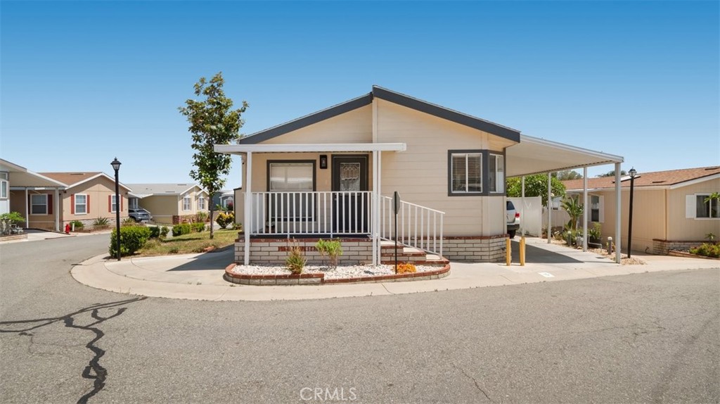 Looking for a home that's MOVE IN ready that can close quickly with upgrades? LOOK NO FURTHER! This beautiful home is nicely tucked into the highly desirable Santiago Estates park of Jurupa Valley/ Riverside. Features 3 spacious bedrooms and 2 full bathrooms, indoor laundry room and a covered car port that accommodates parking for 3 cars. Sits on a corner lot with beautiful views and has a new shed for extra storage. Offering a side yard, perfect for gardening/enjoyment. NEW laminate flooring throughout, Updated kitchen cabinets, NEW INTERIOR PAINT AND A NEW ROOF !! Enjoy an open, airy floor plan that includes a modern kitchen equipped with a pantry, stove, and dishwasher—ideal for both everyday living and entertaining. Located in a peaceful, family friendly, vibrant community, this home offers an abundance of amenities including a remolded Club house perfect to host gatherings, refreshing swimming pool, jacuzzi, playground and basketball court. Conveniently situated near the 60 and 15 Freeway, you'll have easy access to schools, shopping, restaurants and the brand-new Shops at Jurupa Valley which include Ross, In and Out, Gym, Burlington, Aldi, Starbucks, chipotle and many more. Don’t miss your chance to experience all that this property has to offer. Make it yours today and enjoy the perfect blend of resort living, convenience, comfort and community. Financing available, call today!