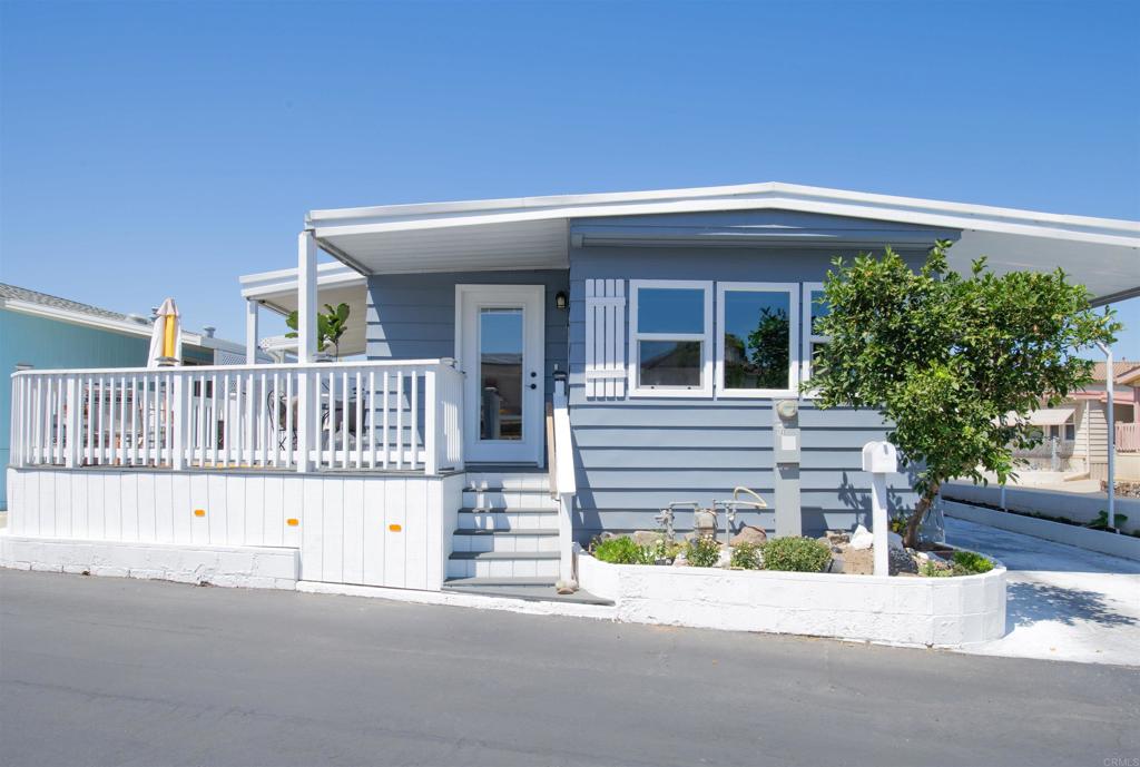 This reimagined home brings indoor and outdoor living together; this is a one-of-a-kind property that will not disappoint. A total of 1,084 square feet (884 sq ft with an attached 200 sq ft sunroom), you get ample space for this 2 bedroom, 2 bath with a bonus den/utility room. Located in San Luis Rey Homes. This is a Resident OWNED 55 + Community, land ownership is involved. The HOA fee is $175/Mo and includes trash, sewer, water & park maintenance. Sit on the trex wrap around deck as you enjoy the cool breezes for one of your many outdoor spaces. This corner lot gives you space to relax outside, plant and maintain a garden, or enjoy an evening fire on the patio. Then when it's ready to go in you will be welcomed by hard surface flooring throughout, granite countertops, dual paned vinyl windows, newer appliances, recently installed walk in shower and all the finishing touches that make this place special. This is the one you have been waiting for, don't let this opportunity pass you by.