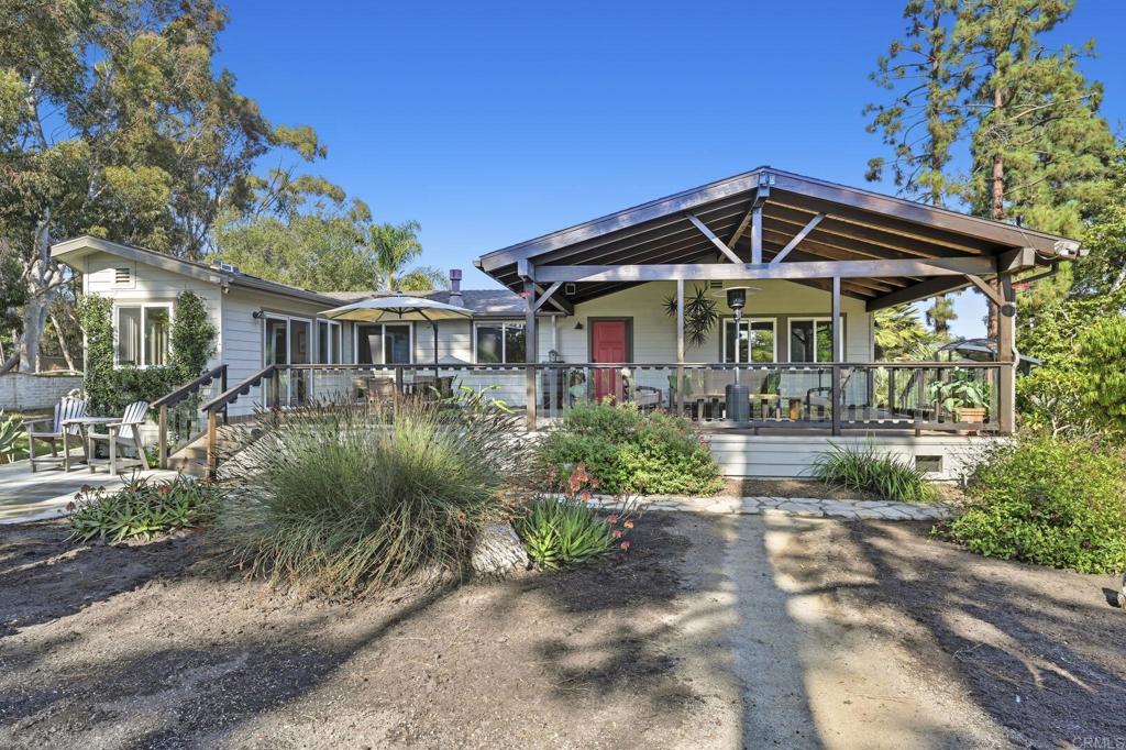 Completely rebuilt in 2015, this custom manufactured home on a permanent foundation has the best location in the Rancho Carlsbad community, where you own the land. This home is uniquely situated at the very end of a cul-de-sac on a huge lot that offers a beautifully peaceful and very private setting, all while overlooking a picturesque display of nature. Linger on the large front deck as you take in the views of sunsets, gorgeous mature trees, exotic birds, and the Aqua Hedionda Creek and adjacent green belt that runs along side the property. Inside, you'll find a spacious, open floor plan offering 2 bedrooms plus a bonus room, vaulted ceilings with large skylights, luxury vinyl plank flooring throughout, a beautiful custom kitchen with designer granite, tons of pantry and cabinet storage, and too many convenient customized details to name. Off to one side of the home you'll find the large primary suite which offers a seemingly endless designer closet, easily accessible shower and luxurious soaking tub. You'll find an extension to the primary suite which provides outdoor access and lots of natural light. -Perfect for spending time lounging, exercising, or enjoying the sunshine. To the other side of the home you'll find an ample sized guest bedroom and bathroom. The third bonus room is light and bright, and perfect for an office space. This home has been thoughtfully designed with a warm color palette, beautiful stone detailed fireplace, large window seats overlooking the picturesque views, and over 2,000 square feet of living space. With an enclosed garage and extra workshop, this property is truly a rare find! Rancho Carlsbad is a premier active adult community conveniently located just minutes from shopping, restaurants, entertainment, medical care, and the coast! The community offers abundant amenities and fun opportunities to connect with others in the neighborhood. Take in the beautiful surroundings of the community while you enjoy tennis, golf, pickle ball, a heated swimming pool, library, clubhouse, and a variety of clubs and other offerings to suit your hobbies. A guarded entry gate and RV parking options make this community a perfect option for anyone looking to enjoy life in paradise.