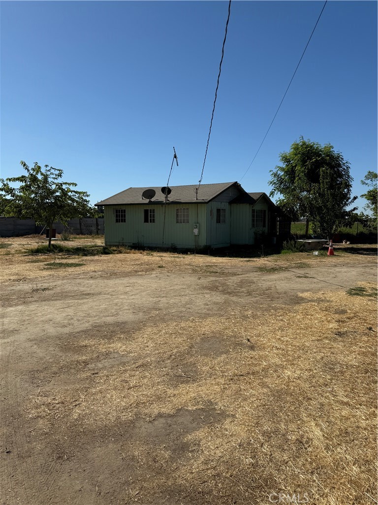 Welcome to your private slice of country life in Merced County! This fully fenced property offers just under an acre of flat, usable land—ideal for those seeking space, privacy, and endless potential. Whether you’re looking for a place to park your RVs, trailers, or work trucks, this property delivers with a large metal carport and attached storage room for all your tools and equipment. The home is a cozy country-style residence with great bones and a ton of character, just waiting for your personal touch. Enjoy the quiet and peaceful surroundings, with beautiful views of open fields and farmland on all sides. A newer well, installed just a few years ago, provides reliable water service. This is the perfect opportunity for anyone looking to live out in the county, enjoy wide open space, and still be just a short drive from town. Affordable, functional, and full of possibilities—this one won’t last long!