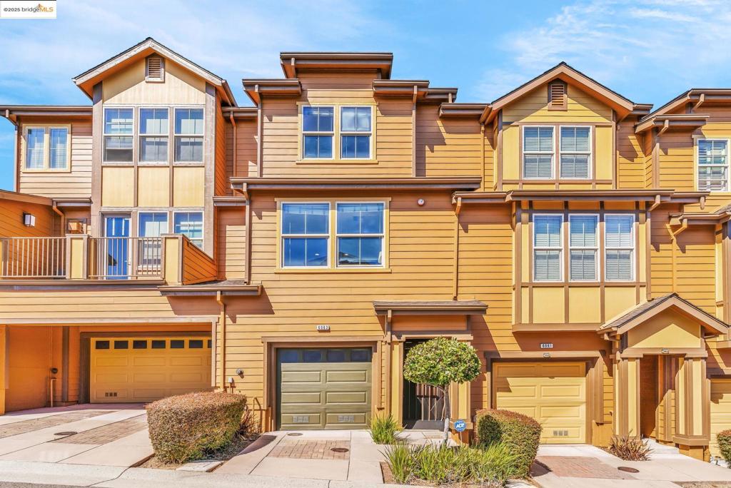 Welcome to 6063 Old Quarry Loop, a chic and contemporary townhome in Oakland, CA. This 1,467-square-foot residence features two bedrooms, three bathrooms with modern comforts such as central AC, forced air heating, and a dining alcove. The property includes a spacious open kitchen and dining concept, laundry facilities within the building, and a club house with a fully equipped gym. Parking is hassle-free with a two-car tandem garage. A charming side yard offers a private oasis for relaxation. Experience modern living with this stylish home that perfectly balances comfort and convenience.