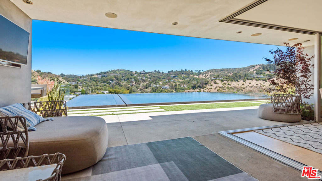 Fully furnished!! Walk into this partially gated Mount Olympus home with city & canyon views. Contemporary style & beautiful views make this an amazing place to call home. The home boasts one of the largest infinity pools in LA & includes 2 MASTER Suites. This 4 bedroom & 4 bathroom home offers a great spot for those looking to be close to the lights & action of the Sunset Strip & enjoy the luxury & beauty of the hills. A breathtaking zero edge infinity pool with spa makes this home one of a kind. The home includes hardwood floors, designer furniture, sliding glass doors, laundry room, walk-in closets, balcony & wet bar. An attached 2 car garage plus ample street parking on a wide street. SEE PRIVATE REMARKS