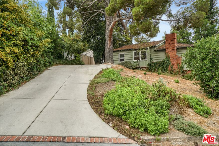 Tucked away in the highly desirable Woodland Hills South, within the private and picturesque Venido/Maycott loop, this residence offers the rare feeling of a tranquil cabin retreat while being just moments from city conveniences. Surrounded by lush greenery and mature trees, the property exudes privacy, serenity, and timeless charm.The home welcomes you with warm architectural details, including wood-beamed ceilings and a classic brick fireplace that anchor the main living spaces with character and comfort. Large windows frame sweeping canyon and city views, bathing the interiors in natural light. The open chef's kitchen is designed for both culinary creativity and connection, seamlessly flowing into inviting living and dining areas.Step outside to a sunlit patio that invites you to savor morning coffee, host gatherings, or simply unwind while taking in the peaceful backdrop of nature. Mature landscaping enhances the grounds, creating a sense of being immersed in your own private retreat.Adding to its versatility, the property includes a fully permitted ADU with its own address, 22458, currently occupied on a month-to-month basis. This space can be delivered with the tenant in place, offering immediate rental income, or delivered vacant for use as a guesthouse, home office, or private studio.Additional highlights include a two-car garage, ample driveway parking, and a location that strikes the perfect balance between seclusion and accessibility. Just minutes from Topanga Canyon, Ventura Boulevard, and local parks, this home captures the essence of California living: peaceful, private, and endlessly inviting.A rare opportunity to own a home that feels worlds away yet right at the heart of Woodland Hills South. Feel free to park in the driveway when visiting.