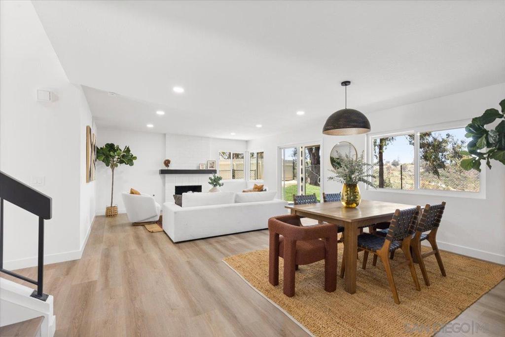 Modern Spanish-style 4 bed, 3 bath home in the highly desirable Mesa Pines community with stunning views from nearly every room! Featuring a chef’s kitchen with a full suite of stainless-steel appliances, slab-front cabinets a peninsula breakfast bar with waterfall edge and designer lighting. Direct backyard access from the spacious formal living and the family room gives the home a remarkable indoor-outdoor flow. The stylish tile-accented staircase leads you to 3 of the 4 bedrooms including an expansive primary suite that offers vaulted ceilings, a private balcony with breathtaking views, a walk-in closet, and a luxurious en-suite bathroom with dual vanities and custom tile finishes. 1 bedroom and full bath on the main level offers flexibility and privacy for extended family, guests, or the potential to convert into an ADU. Relax or entertain in the serene backyard or enjoy the nearby community pool and walking trails. Upgraded with new plumbing and HVAC—this home truly has it all!