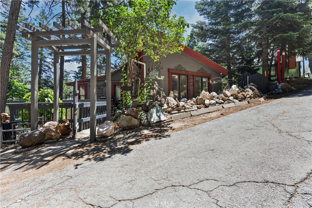 Welcome to 25108 Grandview Drive, a charming mountain cabin nestled in the tranquil woods of Crestline. This cozy home offers vintage character throughout, including high ceilings, a wood-burning fireplace, and rustic wood-frame construction. Set on a spacious lot, the property features peaceful forest views and outdoor potential for entertaining friends and family. A bonus lower-level basement adds plenty of additional storage or workshop space that could possibly be converted later. Ideal as a weekend retreat, full-time residence, or investment opportunity, this home is located minutes from Lake Gregory, hiking trails, and Crestline Village. Whether you’re looking to enjoy mountain living or capitalize on rental income potential, this cabin offers classic charm with room to personalize and make your own. Some photos have been electronically staged.