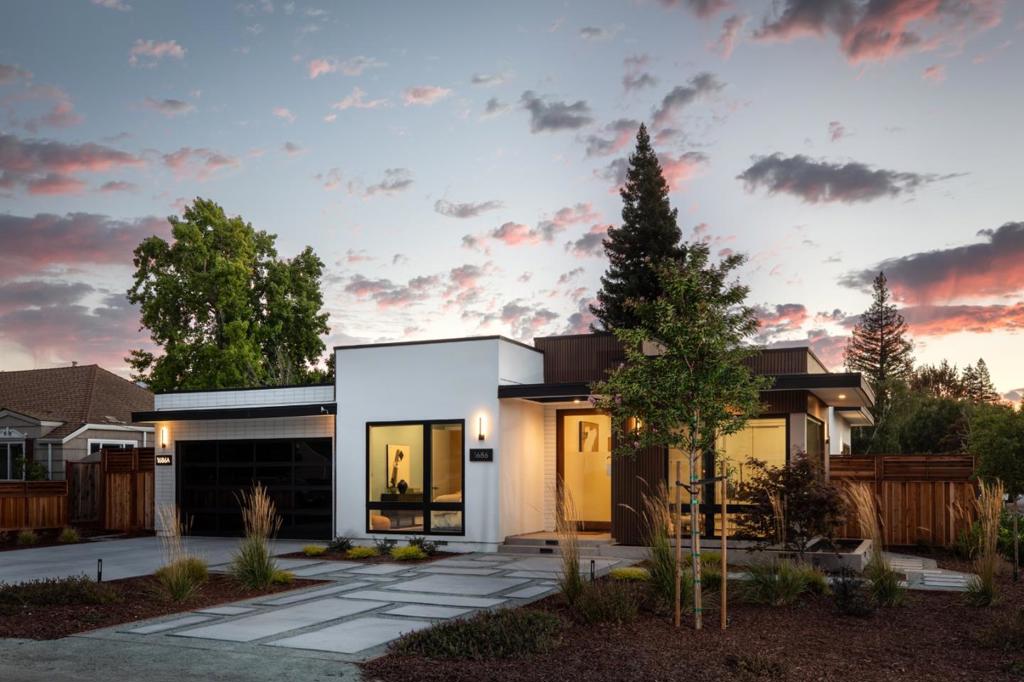 This ultra-modern home, built in 2024, offers sleek design with a wraparound linear reflecting pool, spacious open-concept floor plan on one level, and the added advantage of a fully independent ADU with its own address. The 4-bedroom, 4-bath main home begins with a pivoting glass door opening to an expansive great room with retractable glass wall to the rear yard, a gourmet kitchen with counter seating, and a separate wine bar. The primary suite features dual walk-in closets, a luxurious spa bath, and direct outdoor access. Entered through its own gate, the 2-bedroom, 2-bath ADU shares the rear yard with a retractable glass wall and includes a full kitchen and laundry hookups, creating flexible space for rental income or extended family living. Eco-friendly synthetic lawn, a 2-car garage, proximity to shops and restaurants, and access to renowned Cupertino schools complete this property.