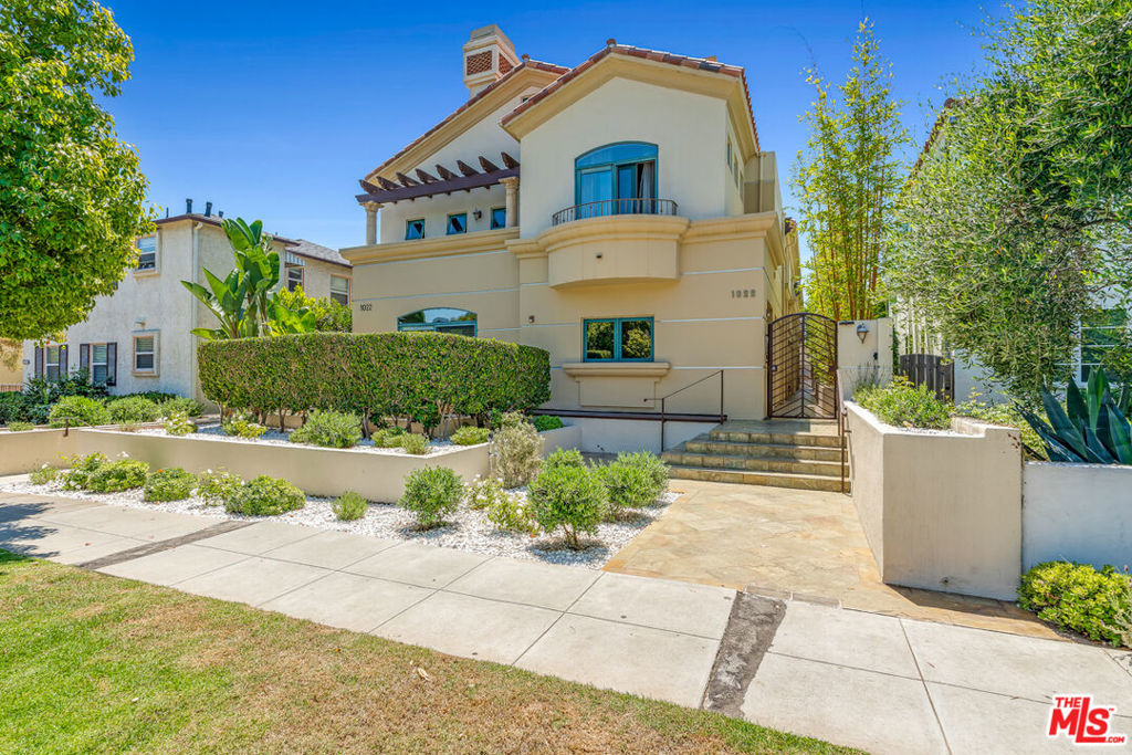 In Santa Monica's coveted North of Wilshire neighborhood, this Mediterranean-inspired townhome blends comfort, style, and an unbeatable location. Enjoy direct access from your private two-car garage to an open living, dining, and kitchen area with a decorative fireplace and private patio. Upstairs, the primary suite features vaulted ceilings, a walk-in closet, a spa-like bath, and its own private balcony, plus a second bedroom and a versatile top-floor den. Three outdoor spaces, including the balcony, a living room patio, and a rooftop deck with views, make this home ideal for relaxing or entertaining. Available for 14 months or longer in a gated community just steps from shopping, dining, and the beach.