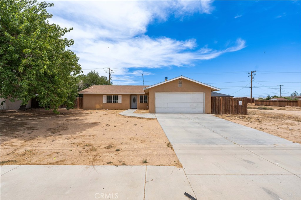 Welcome to 20913 90th Street, nestled in the enchanting desert town of California City. This delightful home offers 3 bedrooms, 2 bathrooms, and a generous 1,539 square feet of living space, all situated on an expansive 9,583 square foot lot complete with an attached 2-car garage. Upon stepping inside, you'll be greeted by a spacious living room adorned with soft carpeted floors and a cozy fireplace—a perfect setting for creating lasting memories with friends and family. Adjacent to the living area lies the chef's kitchen, boasting modern appliances, ample storage, and generous counter space. The kitchen's tiled counters and recessed lighting add a touch of elegance to this desert oasis. This charming desert gem also features three spacious bedrooms, along with two well-appointed bathrooms, ensuring comfort and convenience for all. Moving outside, the backyard presents a blank canvas with endless possibilities. Whether you envision al fresco dining, entertaining under the open skies, or simply unwinding in your own desert haven, this outdoor space awaits your personal touch. Come and experience the best of desert living in the welcoming community of California City. Your ideal home awaits at 20913 90th Street.