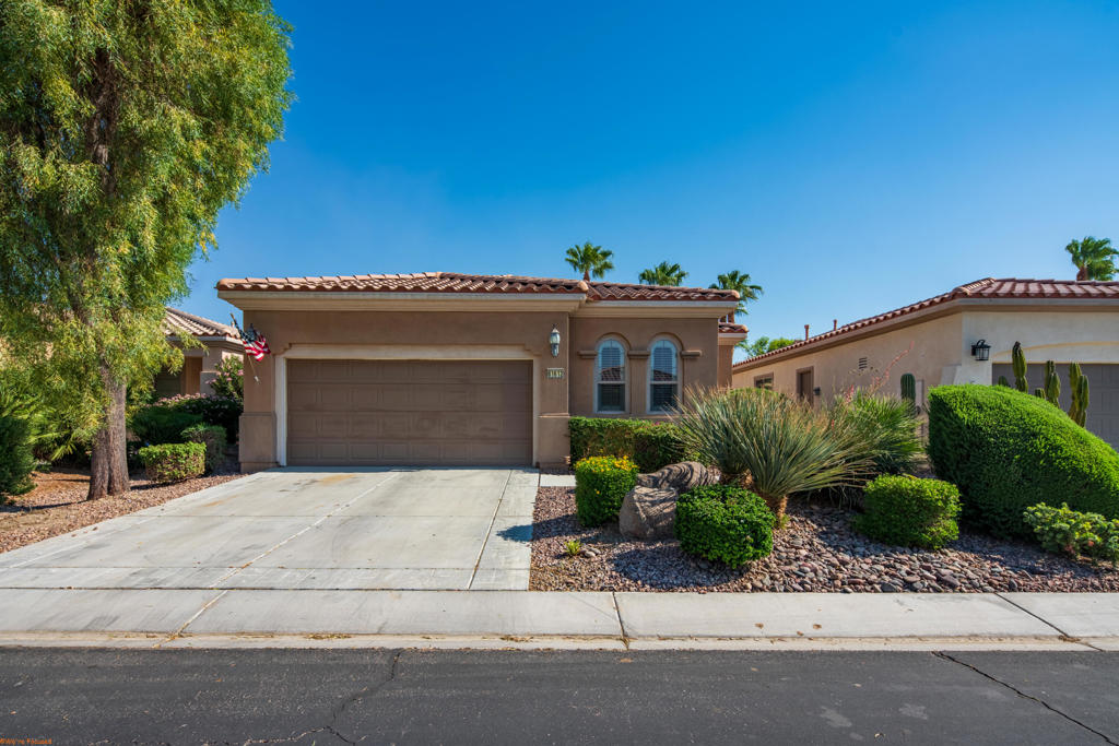 This meticulously maintained Montoya plan boasts approximately 1,432 square feet of living space. The curb appeal is striking, featuring an upgraded front elevation with modern hip roofs and elegant, high arched windows. The property showcases minimal maintenance desert landscaping throughout.Inside, you'll find either tile or wood-look flooring for low maintenance, plantation shutters, blinds, and upscale light fixtures and fans. The kitchen features a cozy dining nook, granite countertops, high-quality cabinetry, stainless steel appliances, and a bar-height countertop that invites guests to gather. The den can easily be transformed into a third sleeping area. The primary suite will comfortably accommodate any king-sized bedroom set and includes dual vanities, a glass-enclosed shower, and a spacious walk-in closet. The laundry room features a deep sink, and the 2-car garage provides ample storage.The backyard patio extends well beyond the covered area, adorned w/stylish pavers that create a perfect space for relaxation in your own private oasis or entertaining friends or family. Enjoy all the outdoor possibilities that this wonderful climate offers.