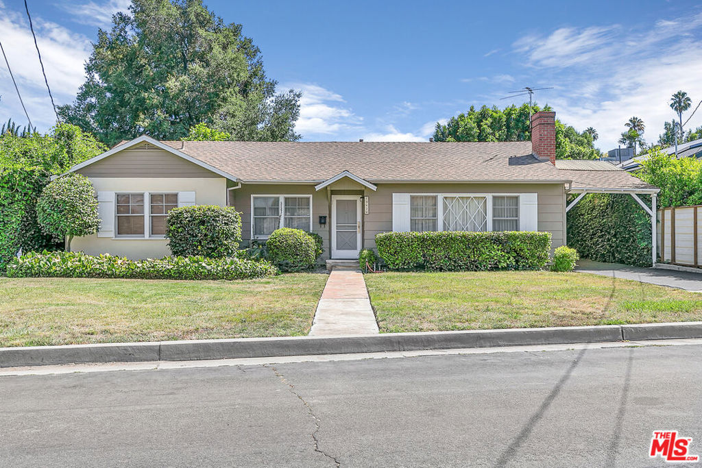 Charming 3-bedroom, 2-bathroom traditional home located on the border of Sherman Oaks and Encino. This well-maintained single-story residence features a spacious living room with a decorative fireplace and large picture window, a separate dining room, and original hardwood flooring throughout. The kitchen offers vintage cabinetry, ample storage, and a cozy breakfast nook overlooking the backyard. All three bedrooms include built-in closets, and there is additional hallway storage. A separate laundry/mudroom leads to the second bathroom and provides access to the backyard.The rear yard includes a covered patio, detached garage, and plenty of space for gardening or outdoor enjoyment. Driveway parking included. Fantastic location close to Whole Foods, the Sherman Oaks Galleria, Arclight Cinema, and popular restaurants and shops.