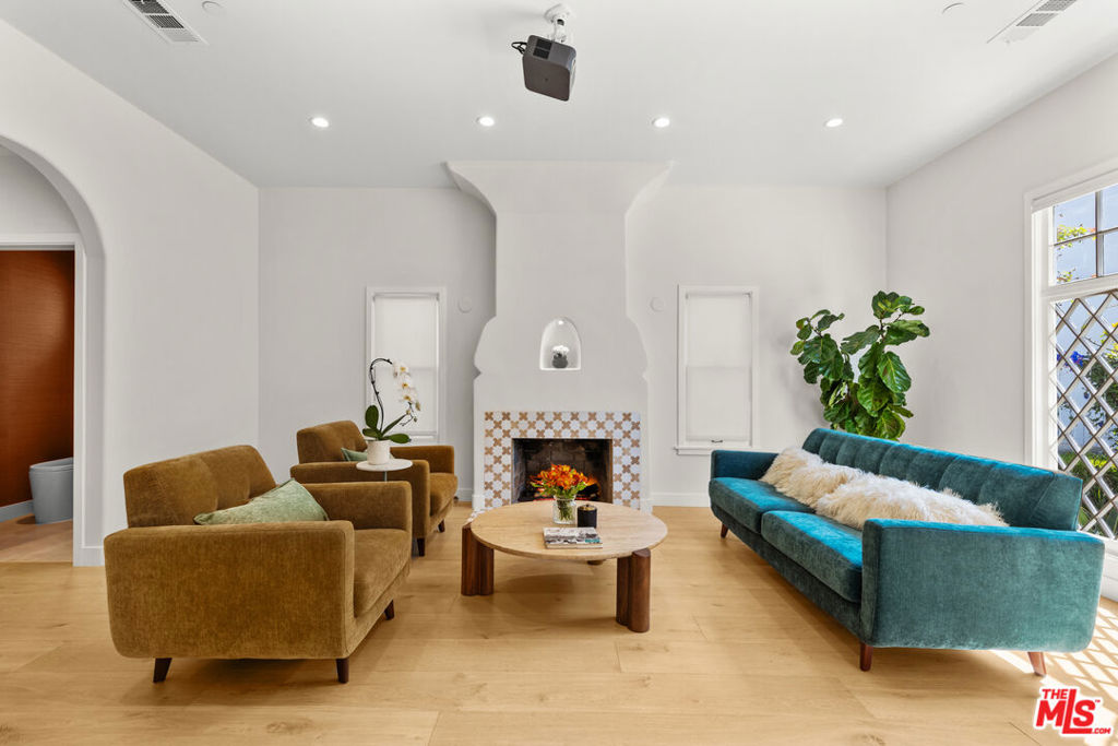 Charming Santa Monica bungalow, meticulously rebuilt from the ground up while preserving its original footprint and timeless character filled with Love! Featuring soaring ceilings, custom-built cabinetry throughout, and restored front windows complemented by custom wood windows to match. The living room centers around a stunning fireplace with handmade Moroccan Zellige tiles, while the chef's kitchen boasts high-end stainless steel appliances, granite countertops, and handcrafted cabinetry. French doors in the kitchen and primary suite open to a lush, private backyard with mature orange and persimmon trees and blooming rose vines. All bathrooms are elegantly finished with Porcelanosa tiles from Spain. The detached garage has been transformed into a fully permitted ADU with its own designer kitchen and bathroom, perfect for office, guests or rental income. Ideally located north of Wilshire, just moments from Montana Avenue, Ocean Avenue, and easy freeway access