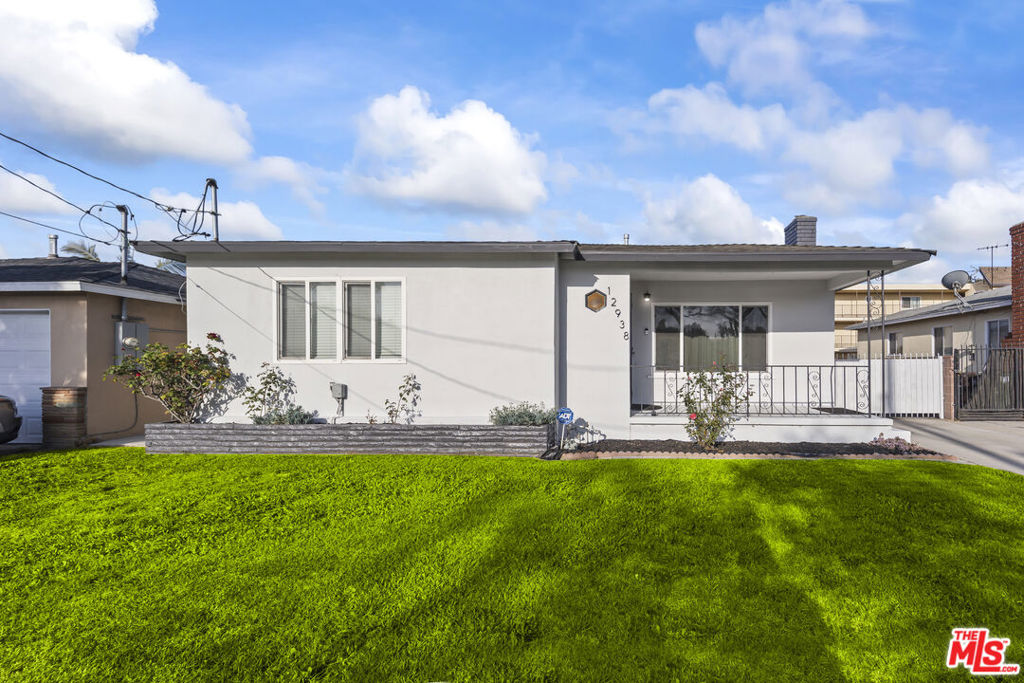 Welcome to 12938 Jefferson Avenue, a charming 3-bedroom, 2 bathroom home located in the heart of Hawthorne. This delightful residence boasts an inviting open floor plan where the living room seamlessly flows into the kitchen and dining area, creating a warm and welcoming atmosphere. The kitchen is a highlight, featuring an abundance of storage, an oversized refrigerator, a stainless steel dishwasher, and a modern stove, making it perfect for both everyday living and entertaining. Both bathrooms have been thoughtfully updated to provide a fresh and contemporary feel. Convenience is at its best with a long driveway for off-street parking, making unloading groceries or luggage a breeze. The home offers the added comfort of air conditioning for those warm California days, and the convenience of inside laundry with washer and dryer hookups. With the spacious back patio, you can enjoy al fresco dining or simply relax outdoors. Located just minutes from the beach, LAX, the Westside of LA, and major freeways, this home truly embodies the saying "location, location, location." Plus, you'll be near a variety of dining and shopping options. Don't miss out on this great home!