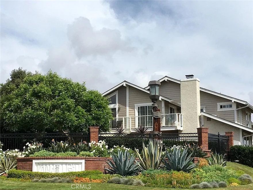 Tucked within the gated coastal enclave of Dana Light, this upstairs home offers the ease of single-level living with 1,400 square feet of airy, light-filled space. Positioned directly above its own private garage, the residence enjoys a sense of privacy and openness, elevated by vaulted ceilings in both the main living areas and the primary suite. A welcoming living room with fireplace flows seamlessly into the dining area and kitchen. The kitchen is finished with granite countertops, stainless electric range, and breakfast bar seating, creating a natural gathering place. Two private balconies—one extending from the living room and another from the primary suite—invite coastal breezes and outdoor relaxation. The primary suite features vaulted ceilings, dual closets, and an en-suite bath with a walk-in shower. Two additional bedrooms offer flexibility, while the second bath includes a classic tub/shower combination. Additional highlights include luxury vinyl plank flooring in the living areas, carpet in the bedrooms, and an in-unit laundry room with cabinet storage. Residents of Dana Light enjoy resort-style amenities including a gated entry, pool and spa, tennis courts, and a premier location close to Dana Point Harbor, Lantern District dining, and the area’s world-class beaches. This is coastal living made effortless—single-level, spacious, and set in the heart of Dana Point.