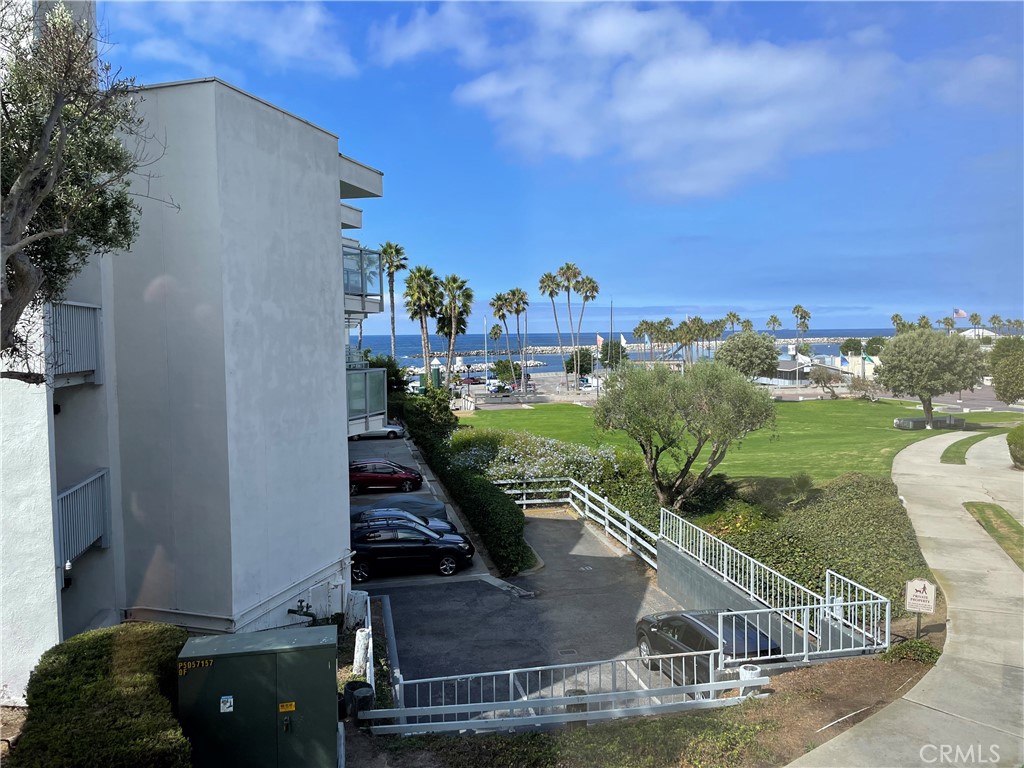 Welcome to this sun-drenched unit that offers a truly spectacular ocean view.  It is a freshly painted, corner unit located on the first floor in the Seascape One complex.  You will enjoy a spacious, open living room with atrium windows and sliding glass doors leading out to the large corner balcony. The interior has beautiful maple finish cabinets, granite countertops, and kitchen bar with all stainless appliances.  Additional features include light oak finish Pergo flooring, crown molding and recessed lighting.  This one-bedroom unit also includes a bonus room that can be used as a second bedroom, den, or office. The bathroom is finished with glass tile insets and granite countertop. One parking space with storage is included.  Just steps away from the laundry room, pool, jacuzzi and beach where you can feel the ocean breeze and enjoy the warmth of the sun.