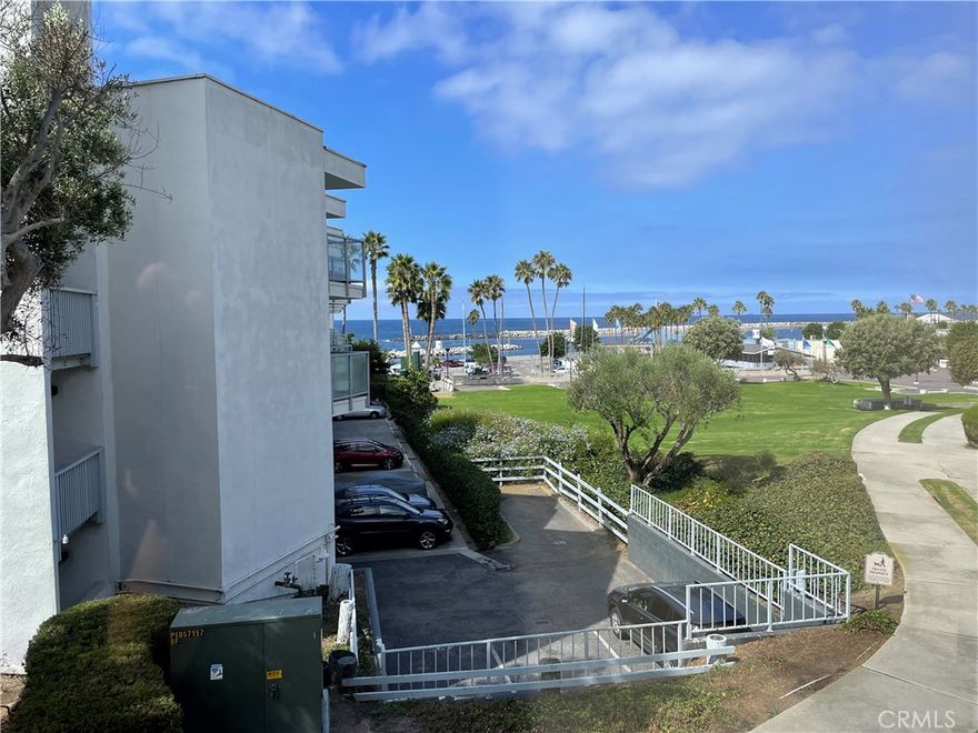 Welcome to this sun-drenched unit that offers a truly spectacular ocean view.  It is a freshly painted, corner unit located on the first floor in the Seascape One complex.  You will enjoy a spacious, open living room with atrium windows and sliding glass doors leading out to the large corner balcony. The interior has beautiful maple finish cabinets, granite countertops, and kitchen bar with all stainless appliances.  Additional features include light oak finish Pergo flooring, crown molding and recessed lighting.  This one-bedroom unit also includes a bonus room that can be used as a second bedroom, den, or office. The bathroom is finished with glass tile insets and granite countertop. One parking space with storage is included.  Just steps away from the laundry room, pool, jacuzzi and beach where you can feel the ocean breeze and enjoy the warmth of the sun.
