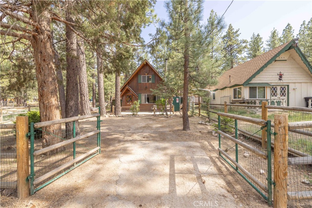 Charming Big Bear Cabin Retreat!
Tucked away on an oversized, level lot surrounded by towering pines, this cozy cabin offers the perfect escape to the mountains. With one bedroom and a spacious loft, plus a full bathroom on the main floor, it’s the ideal blend of rustic charm and comfort. The vaulted wood-beam ceilings and freestanding wood-burning stove create a warm, inviting atmosphere, while the cabin’s deep setback from the street provides extra privacy and that “away from it all” feeling.
Located in a highly sought-after pocket of Big Bear City, you’ll love being near the seasonal stream that runs beside the home—adding a peaceful, open-space vibe. Enjoy close access to local favorites like the Big Bear Convention Center (home of Oktoberfest), the weekly farmers market, snow play areas, and charming shops and eateries.
Currently used as an Airbnb- Home would make for a great long term rental or second home/primary