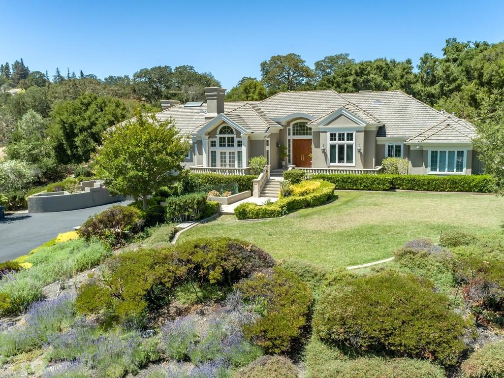 This stunning residence with its Roman architectural detail was masterfully built by renowned builder, Lencioni Construction. Impressive architectural statements include stately columns & balustrades at the entrance, which opens to interiors that showcase rich custom-designed moldings throughout, coffered ceilings, & 3 fireplaces w/hand-carved mantelpieces. Grand-scaled formal living & dining room off the entry. Beautiful chef's kitchen & oversized family room that doubles as a home theatre with its retractable cinema screen & projection system with surround sound speakers. Large library, perfect for todays work-from-home needs. Rounding out the accommodations, & accessed via elevator to the lower level, is a large fitness center & bath, the perfect spot for a wine cellar, plus an oversized 5-car garage with hydraulic lift & custom ventilation system. Outside, the resort amenities include a large pool with a cascading waterfall, separate spa, vast terraces, bocce court, & level lawn.