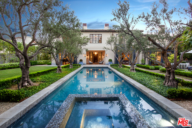 Located in the highly coveted, and Guard Gated, Brentwood Circle. Hip and cool Italian Villa, with interiors recently completed by renowned design team. Every element of this home was masterfully thought through; From the book-matched marble slabs in the kitchen and master bath, custom made steel French doors and windows to the "Waterwork" and "Compass" fixtures, stone from "Exquisite Surfaces", Mahogany windows & doors and the "Savant" & "Lutron" smart technologies. Rooms include living room, dining room, junior dining room, family room, library, office, gym, world class wine cellar, 12 person screening room, mudroom, butlers pantry/bar, covered veranda, 2 terraces and a 6 car, collectors garage. The stunning pool is flanked by olive trees, surrounded by a lush lawn and leads to a guest house. A rare offering. Sq. ft. includes guest house.