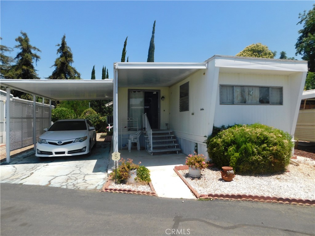 ~ $$Priced to sell!! $$ ~Charming home located in Yucaipa’s highly desirable 55+ community, Carriage Trade Manor!~Low space rent! Only $418!!~Expando off the living room makes it a very spacious and inviting living area!~Kitchen has plenty of counter space and cabinets galore!~Fridge and microwave included!~Kitchen also offers the perfect amount of space to accommodate a dining area!~Full bath in hallway with tub/shower enclosure and vanity area!~Linen storage in hallway!~HUGE primary bedroom with plenty of built-in closet space!~Add-on/bonus room (currently used as a spare bedroom) has laundry hookups (washer/dryer included), and can be used as an office, hobby room, gym, etc!~Swamp cooler AND two wall AC units!~Low maintenance and spacious yard!~Covered carport!~Shed for extra storage!~Beautiful views from your front yard!~Conveniently located by the community pool!~ Call today for a tour and have the opportunity to call this home before it’s gone!~