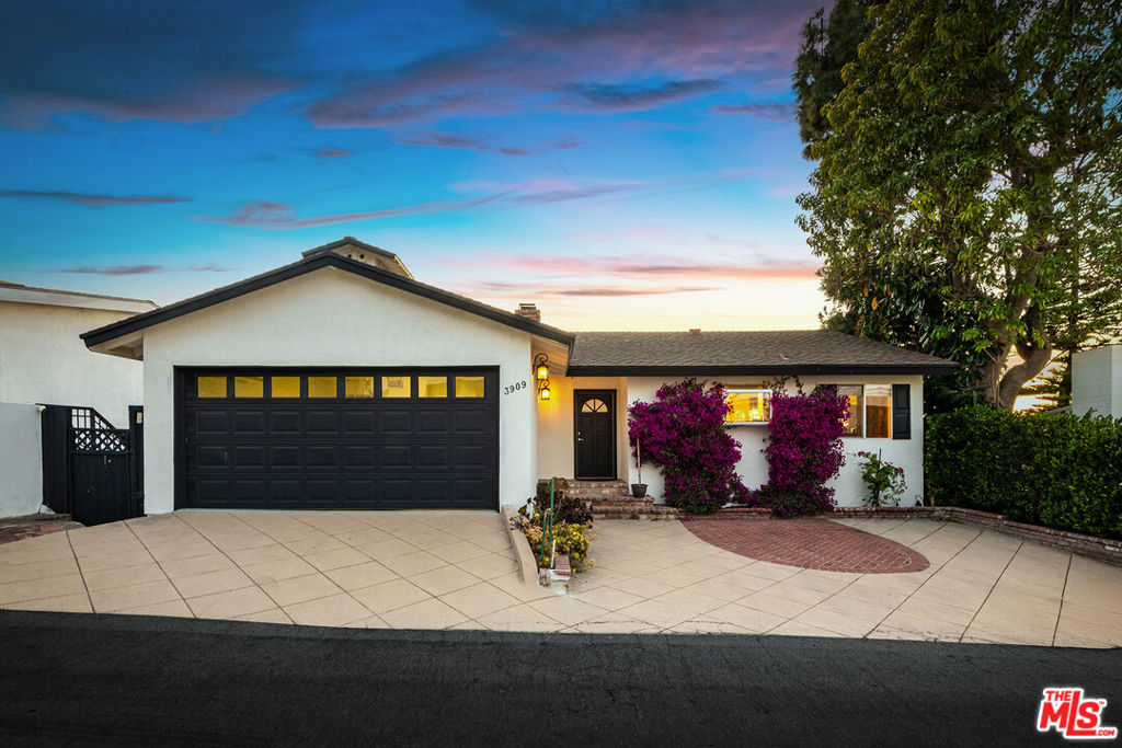 Set high in the hills of Sherman Oaks, this two-level 3-bed, 3-bath retreat offers 2,311 sq. ft. of stylish living space. With panoramic east-facing views of tree-filled canyons and rolling hills, this home brings nature to your doorstep. The main level welcomes you with a sun-drenched open layout, hardwood floors, and a warm fireplace. Walls of glass capture stunning morning light and sweeping vistas of the surrounding greenery. The modern kitchen features stainless steel appliances, granite countertops, and plenty of storage. Downstairs, the primary suite feels like a true escape with breathtaking views, generous closet space, and an en-suite bath. Two additional bedrooms offer flexibility for guests or home office needs. Step outside to an expansive deck and terraced yard ideal for morning coffee, entertaining, or simply soaking in the natural beauty. With charm, privacy, and unmatched hillside views, this is elevated living in the heart of Sherman Oaks.
