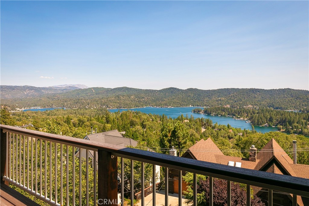 The lake view you’ve been waiting for—at a dream price! Located on one of Lake Arrowhead’s most desirable private streets, this stunning custom-built home on Caribou Drive offers truly panoramic lake views that capture nearly every bay of Lake Arrowhead. Whether you're enjoying summer sunshine dancing on the water, fall foliage reflecting vibrant orange and red hues, or snow-capped trees in winter, this home delivers year-round magic—and a front-row seat to the 4th of July fireworks show.
Built in the 2005 by the original builder-owner and lovingly maintained by just one additional owner since, this residence boasts striking curb appeal with custom cedar siding, stone accents, and plaster exterior. Nearly level entry leads you into a grand foyer with slate flooring and straight into jaw-dropping lake views from the living, dining, and kitchen areas.
The gourmet kitchen is appointed with high-end custom cabinetry, stainless steel appliances, center island, beverage fridge, desk nook, and a spacious walk-in pantry/laundry room. The great room is anchored by a hand-crafted stone fireplace with an Arrowhead motif and a rustic slab mantle sourced from local wood. An additional den off the living room makes a perfect playroom, TV lounge, or home office.
Every window in the home has been replaced within the last year and includes automatic storm shutters for all-season protection. Step outside to a large composite deck designed for low-maintenance entertaining and soaking in the expansive lake views.
Practical upgrades include a Generac 16kW whole-house generator with automatic transfer switch, providing peace of mind during power outages, and two separate heaters—one for each level—for maximum comfort and energy efficiency.
There’s a bedroom and full bath on the main level—ideal for guests or those who prefer single-level living. Upstairs you’ll find two more guest bedrooms with lake views, plus a luxurious primary suite with a fireplace, dual vanities, makeup area, soaking tub, walk-in shower, and large walk-in closet. A flexible bonus room upstairs could be used as a game room, theater, or additional living space.
With a spacious 3-car garage, ample parking, and exceptional craftsmanship throughout, this home is priced to move and ready to impress.
Don’t miss this rare opportunity to own one of Lake Arrowhead’s most captivating lake views—this is a must-see!