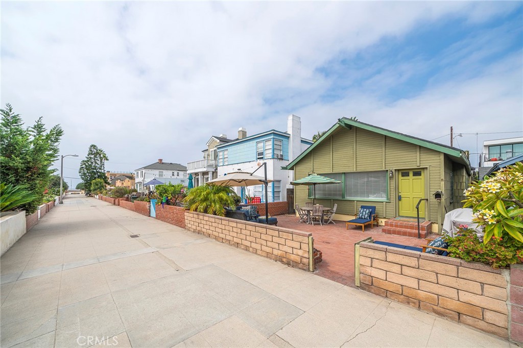 The original "Beach House". This home was moved from its original Strand location. It was a community gathering spot. Now the home sits on 17th street, just steps from The Strand on one of Hermosa's prime walk street locations. The front yard is spacious and well appointed with plants, BBQ, outdoor sectional, dining table, and chaise lounge chairs! Upon entering the home, you will find the main living room open and inviting. Travertine flooring runs through much of the home, with new flooring in two bedrooms. The kitchen is adjacent to the living room with an open floor plan layout, granite countertops, a KitchenAid built-in refrigerator, and KitchenAid appliances. The kitchen was remodeled 10 years ago and has just been freshened with newly painted cabinetry. The entire home is freshly painted with new window coverings. The furnishings have been recently purchased for this amazing rental. The high ceilings make for a fantastic entertaining space. One bedroom opens up to the living room with french doors, the bed is a Trundle Daybed in this bedroom. This bedroom is very private when the french doors are closed. This bedroom can also make for a fantastic office space. Two additional bedrooms are just down the hallway one has a queen bed and the other a king bed. Two bedrooms have ensuite bathrooms, and the other has access from the hallway to one of the bathrooms. All bedrooms have mounted TVs for your viewing pleasure, as well as ceiling fans too! Laundry is to the rear of the home for your private use.