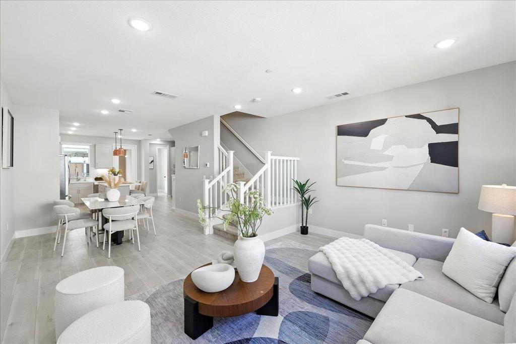 Discover upgraded modern luxury in this 2022-built, like-new contemporary townhome in Sunnyvale's vibrant Elev8tion community! Spanning three beautifully designed levels, this move-in ready home features 3b3.5b across 1,718 sq. ft., including a private first-level bedroom suite ideal for guests or rental. The heart of the home is a stunning open-concept great room with soaring high ceilings, combining a chef's dream kitchen with top-of-the-line appliances, ample storage, and a spacious living and dining area bathed in natural light, opening to a charming covered deck. Upstairs, two luxurious bedroom suites include a serene primary retreat with spa-inspired bath and walk-in closet. Modern comfort is elevated with premium features, including a water filtration system, 3-zone HVAC, fresh air ventilation. The Elev8tion community enhances your lifestyle with shared amenities including a clubhouse and playground. Popular with Silicon Valley professionals, it is just minutes from restaurants, shops, Downtown Sunnyvale, and major tech employers including Apple, Google, Meta, Nvidia, Amazon & more, with easy access to Highways 101, 237, and Central Expressway. This townhome is not just a house, but a lifestyle statement in a thriving community. Don't miss this Sunnyvale beauty!