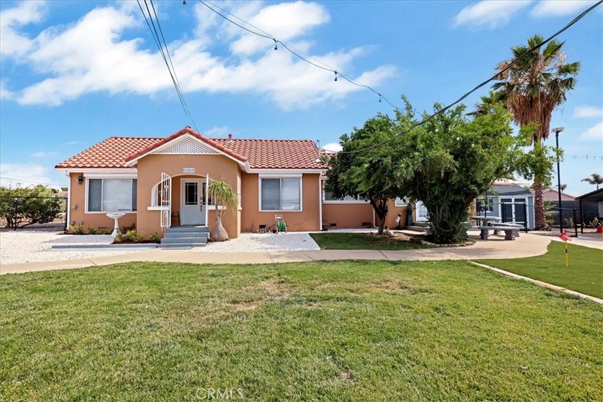 You won't want to miss this stunning Spanish remodeled 3 bed/2bath home that sits on a huge 25,488 sqft. lot. The front porch is charming and welcomes you as you step into the living room and dining room. A welcoming open floor plan incorporates modern flair into this bright and airy dream home. The gorgeous kitchen features white self-closing cabinets, quartz counters and new stainless steel appliances. The master bedroom is spacious with direct access to the front yard. The Master bathroom and guest bathroom remodel include new vanity and tiled shower. Additional features include new A/C and heating system, new flooring, separate laundry room and has two yards. The property has 2 gates (sliding and swing gates) for your privacy and peace of mind if you have small children. TWO ELECTRIC VEHICLE CHARGING STATION INSTALLED (one Tesla and one 220v outlet for non-Tesla electric vehicles). The yard is perfect for unwinding after a long day at work and an area to park your RV and toys. The main yard has a combination of real and synthetic grass with 4-hole mini golf and playground with swing set. There is also a big shade, perfect for weekend barbecue. The property has a Solar system and new shed for your personal properties. This home is conveniently located in a very quiet and pristine neighborhood near University of Redlands, schools, freeways, shopping, churches and hospitals. Property is fitted with security windows through out the house. Security alarm system included. The property has a pomegranate, lemon and grapefruit trees. This is truly a must-see home!