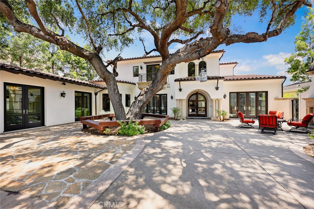 This stunning custom estate blends modern sophistication with timeless elegance, offering every amenity for classic Californian indoor-outdoor living and entertaining. Designed by renowned architect Robert Tong and built in 2015 by Bowden Development, Inc., this one of kind estate sits on over 18,000 sqft lot in one of Arcadia’s most prestigious neighborhoods.
Beyond the gated entrance, a spacious and private front courtyard with a majestic oak tree and outdoor fireplace welcomes guests in true California style. With over 7,040 sqft of thoughtfully designed living space, the home features 5 en-suite bedrooms, 5.5 bathrooms, and a flowing layout adorned with designer finishes, custom lighting, and top-tier materials throughout.
The dramatic 25-foot grand foyer showcases a sweeping staircase and leads to formal living and dining rooms, a private executive office with custom built-ins, and an expansive family room with wet bar overlooking the manicured backyard. The heart of the home features both a modern chef’s kitchen with marble center island and premium appliances, as well as a separate wok kitchen for Chinese cuisine.
Designed for entertaining, the home includes multiple dining areas, a wine room, and a state-of-the-art home theater. The main level also includes a junior suite with walk-in closet, ideal for guests or multi-generational living.
Upstairs, the luxurious master suite offers a serene retreat with a sitting area, custom walk-in closets, spa-like bath, and picturesque views of the backyard. Three additional spacious en-suites and a loft area complete the upper level.
Conveniently located within walking distance to Arcadia’s award-winning schools, golf courses, shops, and dining, this exceptional property exemplifies sleek elegance and modern comfort—a true dream home in the heart of Arcadia.