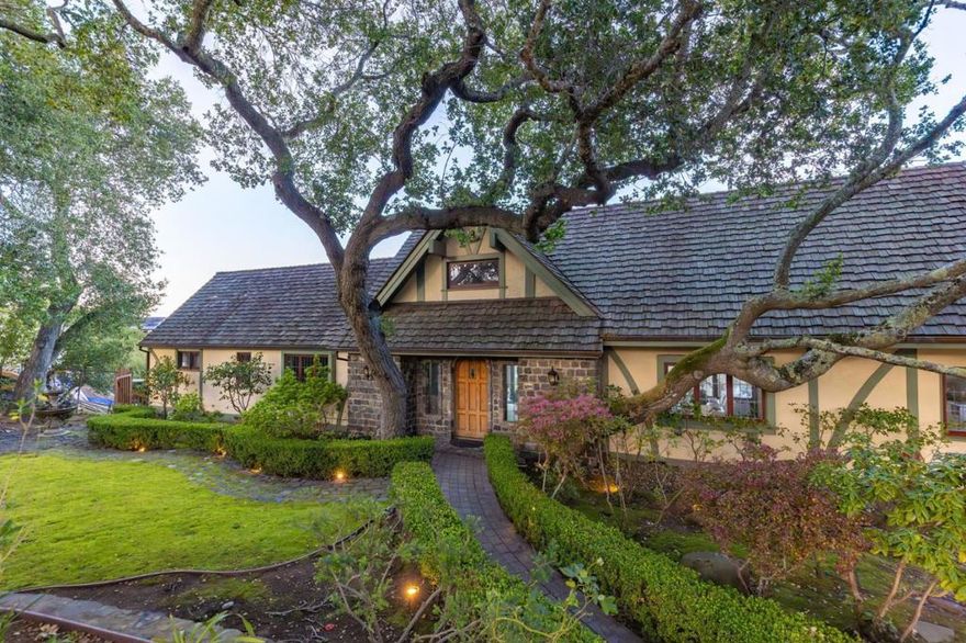 Welcome to 15 Pine Court, where every room offers breathtaking, panoramic views of the San Francisco Bay, from the Golden Gate to the San Mateo Bridge. This hidden gem, nestled among mature oak trees on a private cul-de-sac in the exclusive upper Hillsborough neighborhood, offers an unmatched combination of old-world charm and modern comforts. Step into a gated courtyard and cobblestone-lined entrance that leads to a grand formal living room with vaulted ceilings, a wood-burning fireplace, and expansive windows framing stunning views. The chefs kitchen features top-of-the-line stainless steel appliances, granite countertops, and a spacious breakfast area overlooking lush greenery. A formal dining room, two large bedrooms, and a luxurious master suite with a private den complete the main floor and upper levels. Upstairs, the third level provides an ideal family or entertainment space with a cozy family room, office/5th bedroom, and full bath. Outside, a large, wraparound patio deck with a hot tub offers complete privacy and unparalleled views, all set within nearly an acre of forest-like grounds. This home is the perfect sanctuary for those seeking peace, beauty, and serenity, all with a view like no other.