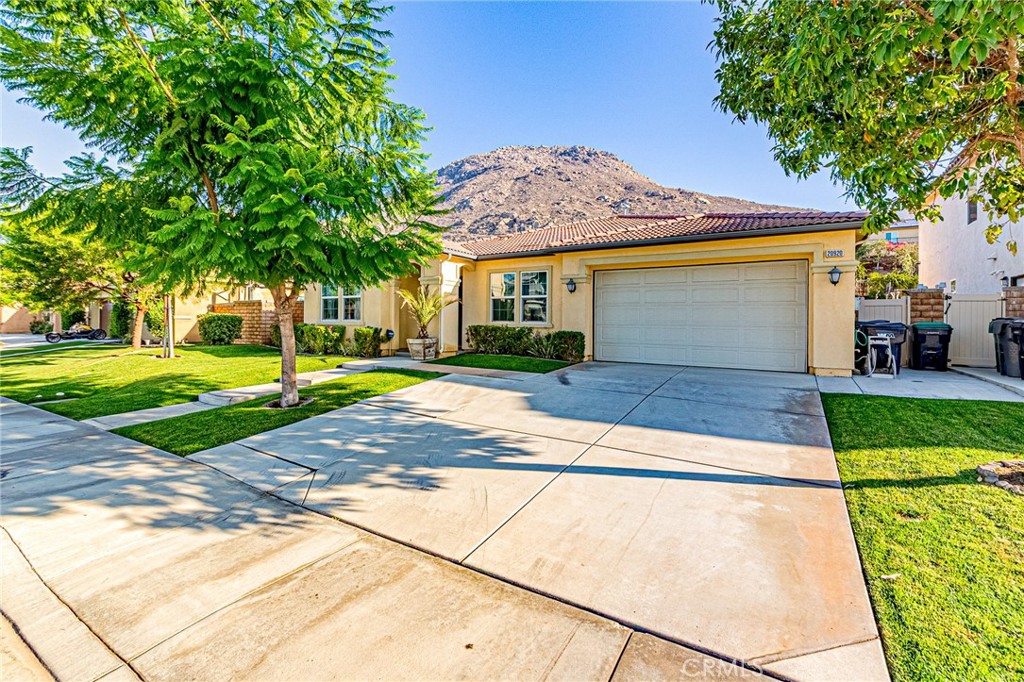 Nestled against the scenic foothills of Riverside’s Spring Mountain Ranch, this beautifully upgraded single-story home offers modern elegance, open living, and breathtaking mountain views. Built in 2018, the home features 4 spacious bedrooms, 3 full bathrooms, and a bright, open floor plan designed for today’s lifestyle.
The modern kitchen is a true showpiece, with white shaker cabinetry, granite countertops, designer glass-tile backsplash, stainless steel appliances, and a large center island perfect for gathering. The walk-in pantry with glass door adds both function and style. The open-concept layout flows seamlessly to the spacious great room and dining area, creating an inviting space filled with natural light and warmth.
The primary suite offers a peaceful retreat with a large walk-in closet and a spa-inspired bath featuring dual sinks, quartz countertops, a soaking tub, and a separate shower. Three additional bedrooms and two full baths provide comfort and flexibility for guests or home office use.
Step outside to enjoy your own private garden oasis—a beautifully landscaped yard with mature fruit trees (including fig, pomegranate, pear, and more), colorful blooms, and sweeping mountain views. The spacious paved patio and covered sitting area offer the perfect setting for outdoor dining or morning coffee surrounded by nature.
Additional highlights include wood-style flooring throughout, recessed lighting, central HVAC, neutral paint tones, and an attached two-car garage with upgraded glass-panel door. Situated on an 11,326 sq ft lot with no HOA, this home combines privacy, modern comfort, and a true connection to the outdoors.
Enjoy access to the community’s 6-acre park with basketball and volleyball courts, playground, and walking trails. Conveniently located near UC Riverside, Loma Linda Hospital, and major freeways (215, 60, 10, and 91).
This is more than a home—it’s a lifestyle. Experience modern living with serene mountain views and a backyard that truly blooms with life.
