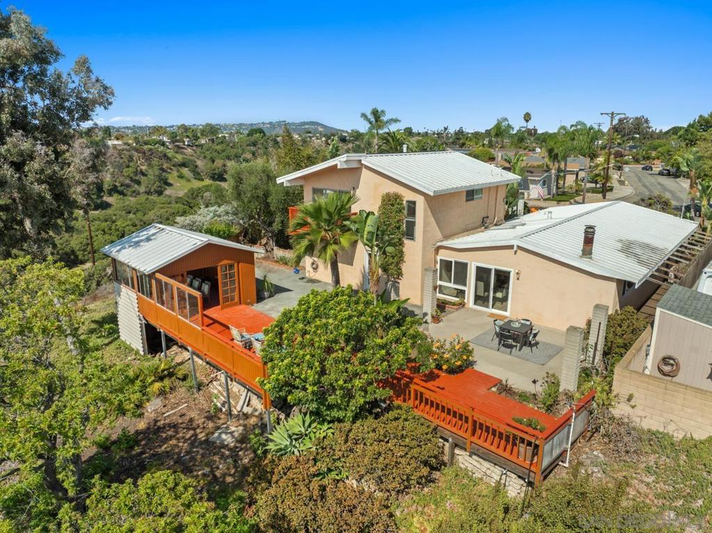 Beautiful Clairemont Canyon View Home with direct access to Tecolote Canyon trail! Welcome to this stunning 4bed, 3bath home with an office, tucked away in a peaceful cul-de-sac in the heart of Clairemont. Set on a large lot with mature landscaping, this residence offers the perfect blend of comfort, charm, and modern updates. Step inside to discover new luxury vinyl flooring throughout and a freshly painted interior with an open floor plan. The chef’s kitchen is a highlight, featuring cherry wood cabinetry, expansive quartz countertops, and a gas-burning stove that will delight any cook. Enjoy peace of mind with major upgrades including a metal roof with owned-solar, a newer furnace, A/C, and roof (approx. 2 years old), a new water tank, and a brand-new garage door with opener. The oversized bonus space offers endless flexibility—ideal as a primary suite with office, guest quarters, or additional living room. Outdoor living is just as inviting, with a large deck and backyard, and a charming closed in gazebo overlooking the canyon - perfect for entertaining, plus a storage shed and extended driveway for convenience. Additional features include: 1-car garage with new door/opener, Large driveway for extra parking, Updated systems and finishes throughout. This home truly has it all, spacious interiors, flexible living spaces, and a prime Clairemont location on Tecolote Canyon.