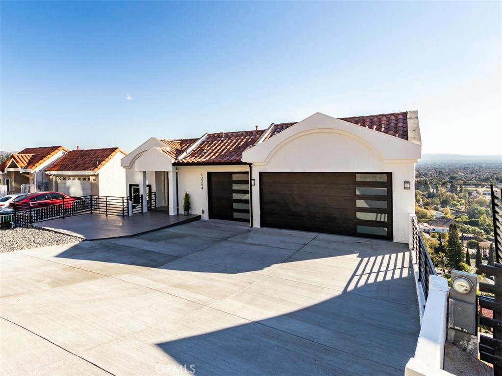 VIEW, VIEW AND MORE VIEWS - This Spanish modern home has been done with tasteful finishes! Welcome to the highly sought out hills of North Tustin. As you drive up the hill, you will instantly notice the beautiful view Circula Panorama offers. This three-story home is nearly 6,000 Sq ft which includes 6 bedrooms, 7 bathrooms, semi-finished basement and a huge bonus room that can be used as a playroom or gym. This home's curb appeal starts with the new poured driveway and tiled front porch. As you enter through the front door, you will be greeted by the high ceilings, natural light and breathtaking views. As you make your way down to the main floor the views are amazing! The open and huge family room provides the space to entertain and enjoy those cozy nights with a beautiful stone tiled fireplace from floor to ceiling. As you make your way into the gorgeous gourmet kitchen you will be able to cook on a new 48-inch 6 burner stove. The kitchen also has a 9-foot island, stainless steel appliances and a waterfall quartz countertop on the kitchen island to give it a wow factor. Behind the kitchen you have a HUGE bonus room that can be used as a gym, playroom or a man cave. This home offers two master bedrooms and all, but one bedroom has its own bathroom. Upgrades include new water heater, 2 new 3-ton AC condensers, recessed lighting, freshly painted interior and exterior, new dual pane windows/sliding doors, new waterproofing flooring, all 7 bathrooms remodeled, sauna room, plenty of storage space, great room, formal dining room with a view, master suite with a walk-in closet, spa-style master bathroom and many more. The home also features a large semi-finished basement for storage, crafts, or possibly a gym (basement space is NOT included in the square footage). This home has it all and it is a must see. The home is just minutes away from Angel Stadium, Disneyland, Orange Hill Restaurant, golf courses, local schools, multiple parks, hiking trails, and much more. Are you ready to move in???