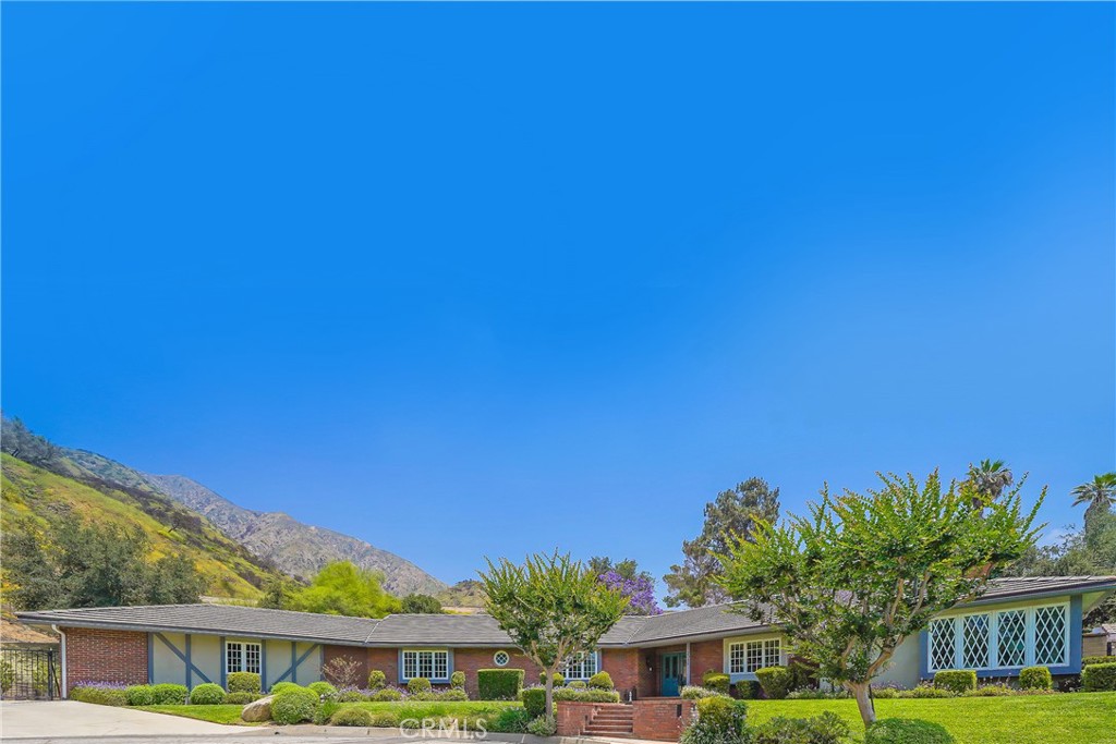 Experience the perfect blend of comfort, luxury, and California charm in this beautifully updated single-level ranch home nestled in north Sierra Madre. Set on a nearly 20,000 sq ft lot, this stunning 3,174 sq ft residence offers three spacious bedrooms and three bathrooms, creating an ideal setting for both everyday living and exceptional entertaining. From the moment you enter, you will be drawn to the heart of the home. A gourmet chef’s kitchen, fully renovated with high-end appliances, generous counter space, and stylish finishes. The open-concept layout flows effortlessly into expansive living areas, complete with a full bar, perfect for hosting gatherings of any size. Multiple sliding doors off the den invite you to step outside into your private resort-style retreat. A sparkling pool with a soothing waterfall, baja step and attached hot tub sets the tone for relaxation, while the outdoor kitchen, patio, and cabana with fireplace and TV make entertaining a breeze. Whether you are hosting summer BBQs, catching a game, or unwinding under the stars, this outdoor space is designed for year-round enjoyment. Inside, is a dedicated laundry room and central heating and air conditioning to ensure year-round comfort. Car enthusiasts and hobbyists will appreciate the attached three-car garage, equipped with epoxy flooring, portable cabinetry, refrigerator, TV, a Level 2 EV charger, and a convenient half bathroom. A large driveway and extra storage sheds provide additional flexibility and convenience. With city views to the south and natural landscaped hills to the north, every detail of this home has been thoughtfully curated for comfort, functionality, and style.