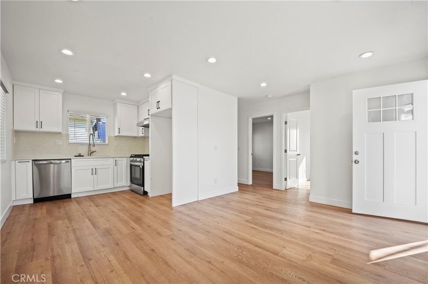 Experience modern living in this beautifully remodeled, 2-bedroom, 1-bathroom apartment thoughtfully updated for comfort and style. The open-concept layout features a sleek kitchen with quartz countertops, custom cabinetry, and modern appliances. Enjoy the convenience of A/C and heating, recessed lighting, durable vinyl flooring, a spacious walk-in closet for effortless organization, and 1 assigned parking space.