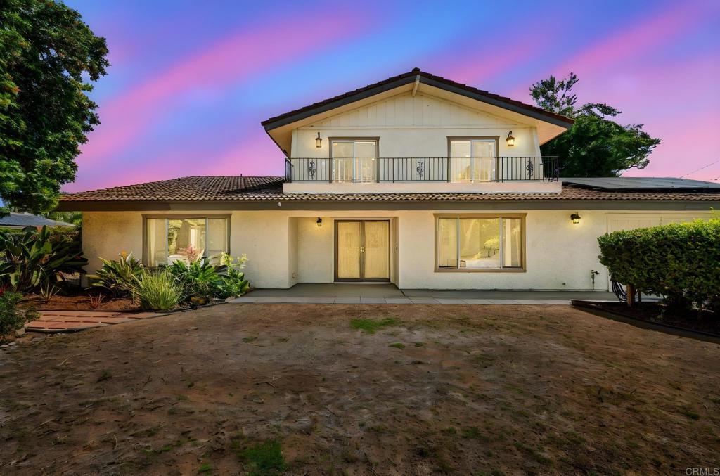 Wake up to breathtaking mountain sunrises and unwind with sparkling ocean sunsets at this hilltop retreat in Vista. This 5-bed, 5-bath, nearly 3,000 sq ft home sits on almost a full acre, offering a rare blend of privacy, space, and panoramic views. Inside, the open, light-filled layout features a versatile floor plan with 3 bedrooms upstairs and 2 bedrooms downstairs, an additional converted garage bedroom and full bathroom, and dining room that can convert to an additional bedroom—perfect for multi-generational living, guest quarters, or a home office. A detached structure provides additional potential for a studio, gym, or creative space. The outdoor areas are just as impressive. Tiered landscaping, mature trees, and multiple patio spaces create the ideal setting for entertaining, gardening, or relaxing in total seclusion. With over 40 leased solar panels, your energy bills can stay low while your lifestyle stays big. Located in a quiet neighborhood with a peaceful countryside feel-yet just minutes from shopping, dining, schools, and the coast-this property offers the best of both worlds. Property highlights include panoramic mountain and ocean views, 5 bedrooms with 2 additional bedrooms on bottom floor / 5 full bathrooms, detached bonus structure, nearly 1 acre of landscaped, tiered outdoor space, fully leased solar system (40+ panels), flexible multi-level layout for guests or extended family, peaceful location minutes from amenities and beaches, and tiered landscaping perfect for an additional ADU or RV Parking. Experience the beauty, privacy, and potential of 326 Sunrise Circle in person—you won’t want to leave.