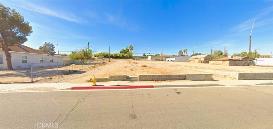 Ready-to-build 0.17-acre residential lot on paved E Fredricks St in established Barstow neighborhood. Flat terrain with electricity at street, public water and septic available - minimal hookup costs for immediate development. Strategic location just minutes from I-15 and I-40 interchange provides direct access to Los Angeles (116 miles) and Las Vegas (155 miles). Residential zoning allows single-family construction in growing transportation hub anchored by BNSF Railway and expanding logistics sector. Barstow's median home price of $270,851 and steady 1.4% annual land appreciation create strong investment fundamentals. Desert climate with 281 sunny days annually appeals to year-round residents and vacation home buyers. Property sits in historic Route 66 corridor near Calico Ghost Town, Outlets at Barstow, and Mojave National Preserve attractions. Well-drained sandy loam soils suitable for construction with minimal site preparation required. City utilities eliminate costly septic installation while paved road access ensures year-round accessibility. Perfect for first-time builders, investors, or desert lifestyle seekers. APN 0181-151-05-0000. Priced at $21,900 for quick sale in this emerging high-desert market.